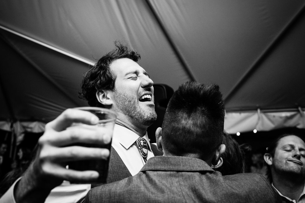 big-sky-montana-gallatin-riverhouse-wedding-groom-drinking-beer-laughing.jpg