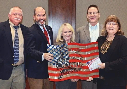 Presenting metal artwork used to raise funds for the Wildlife Department's Stars & Stripes License Project are, from left, Department Wildlife Chief Alan Peoples, Department Director J.D. Strong, Department Assistant Director Melinda Streich, James Dietsch and Laura McIver, both of Central Oklahoma Quail Forever.