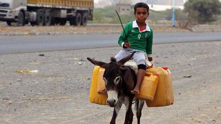 A boy carries water in plastic containers outside of Hodeidah, Yemen. (AFP/Getty Images)