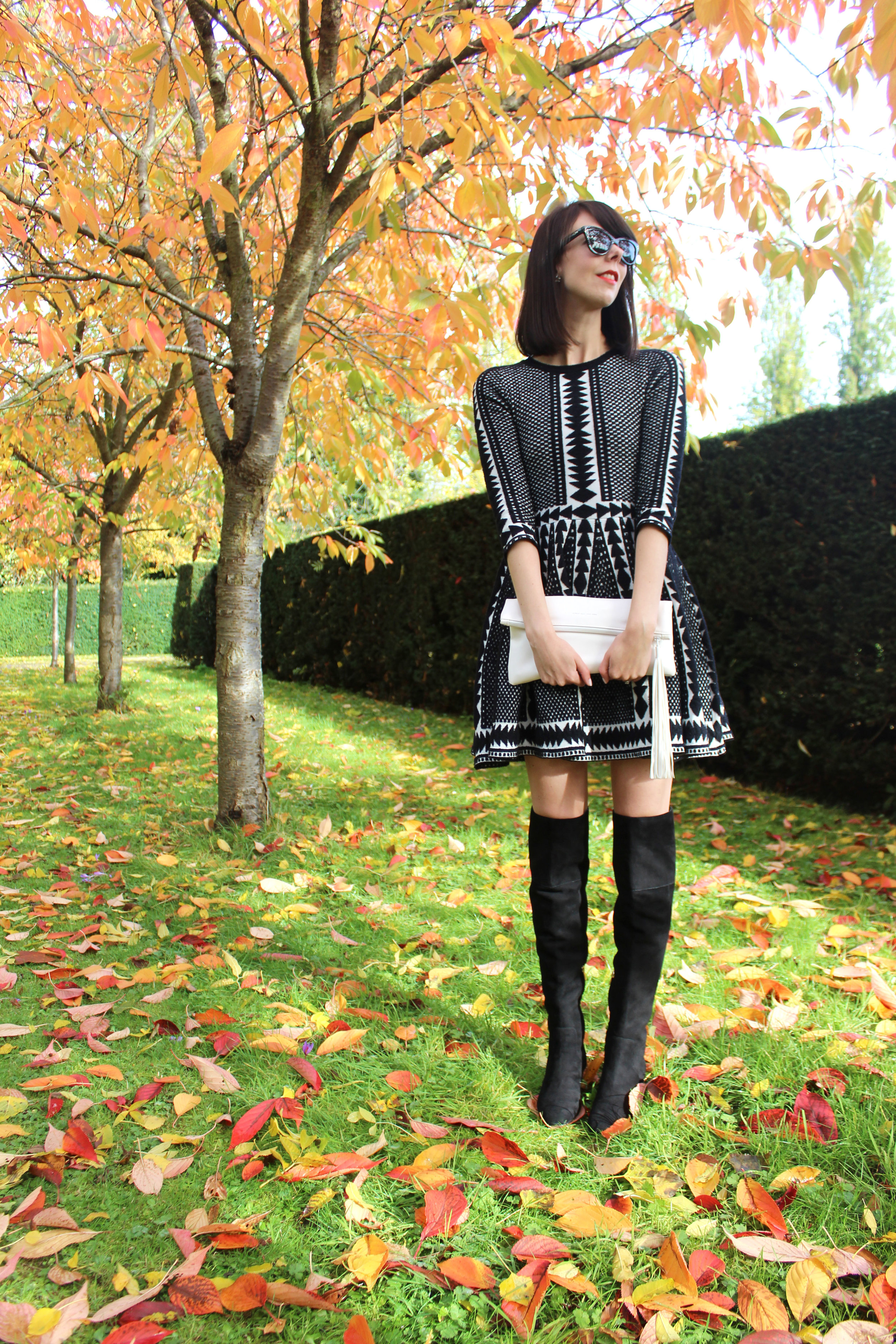 Suede over the knee boots and a cozy black and white sweater dress.