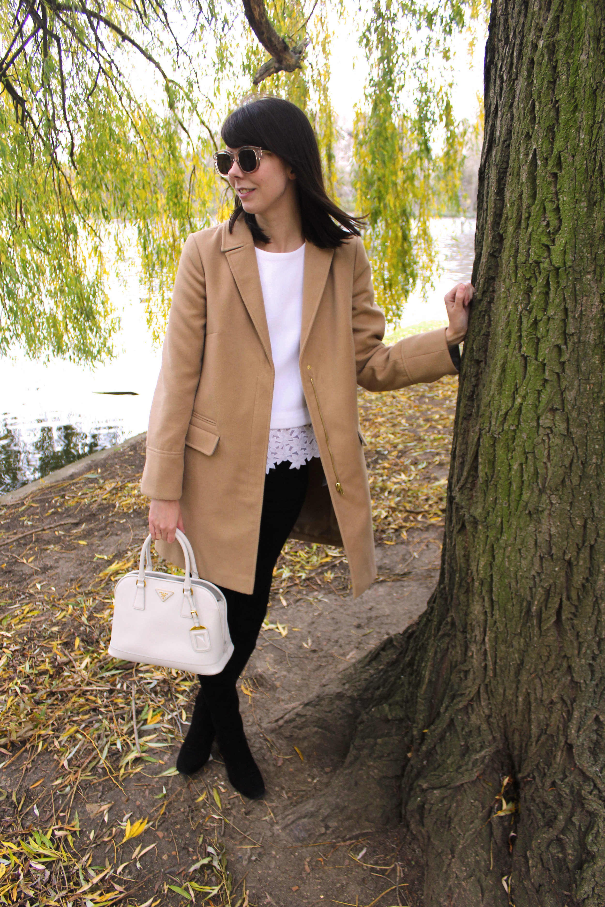 Standing beneath the willow trees in Regent's park wearing suede over the knee boots, a camel coat, and a Prada bag.