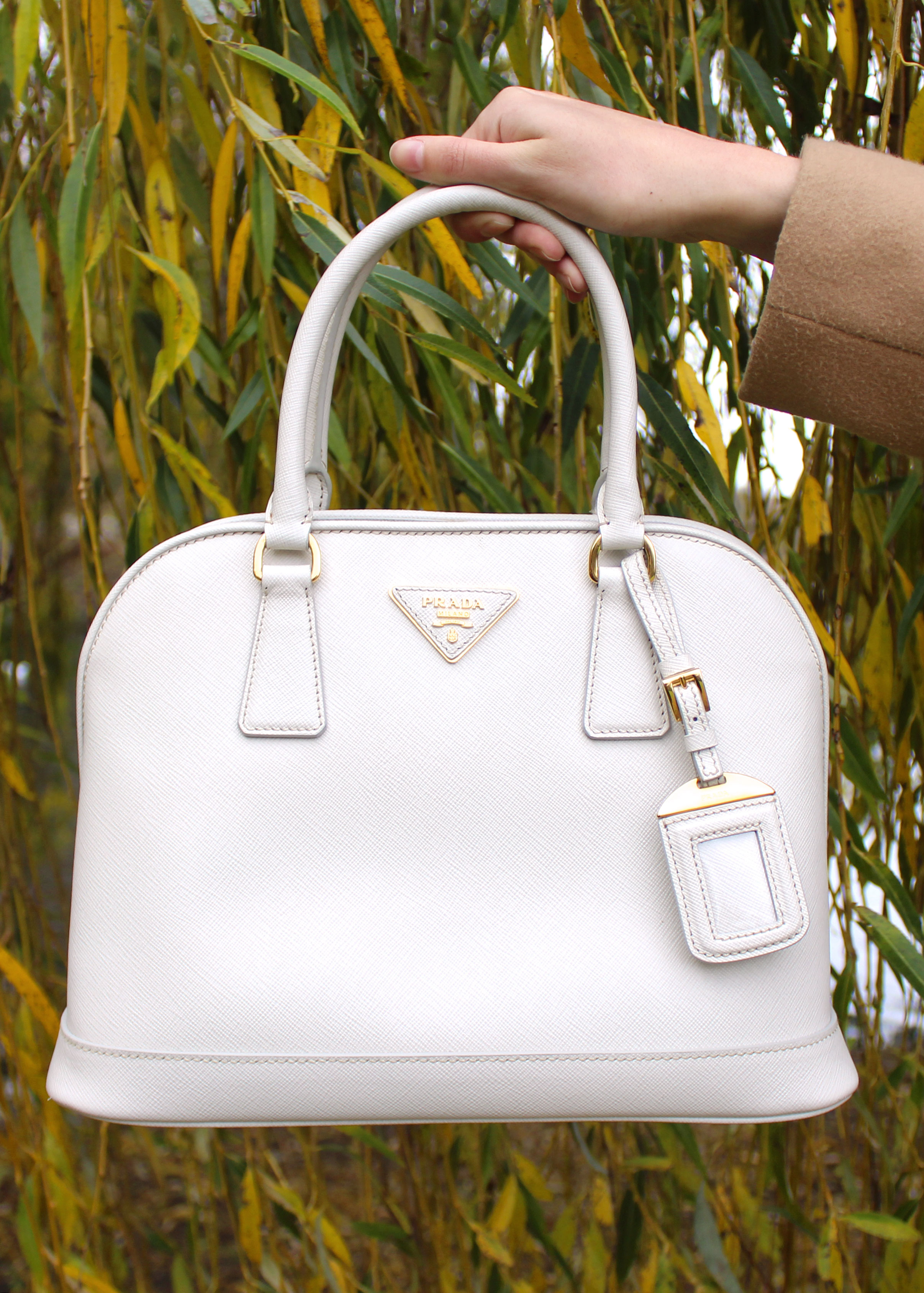 White Prada saffiano leather bag.