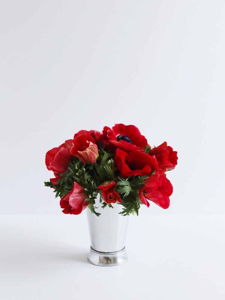 Red anemone flowers in a silver mint julep cup make a cute floral centerpiece for derby day.