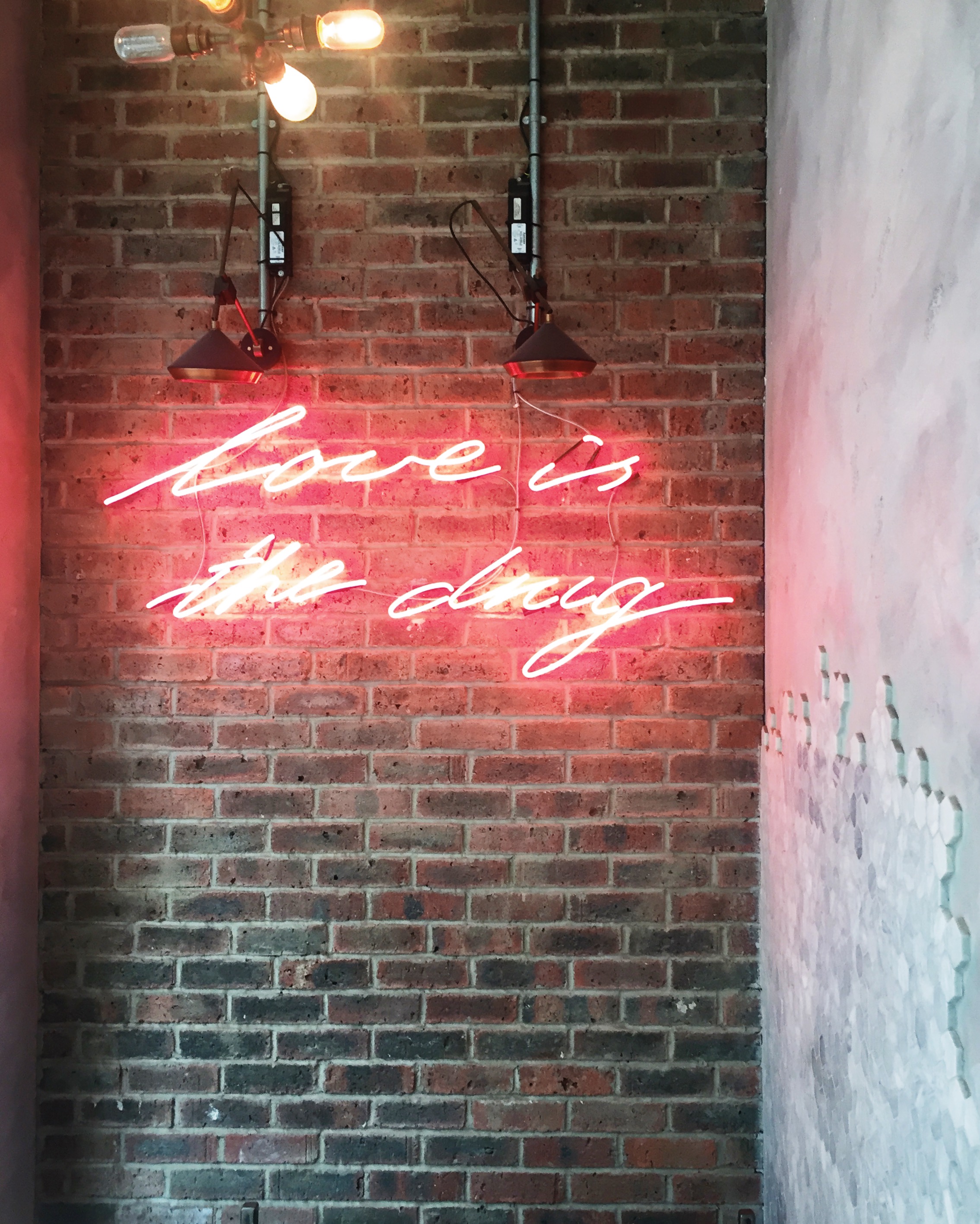 'Love is the drug' neon sign at The Holborn Grind.