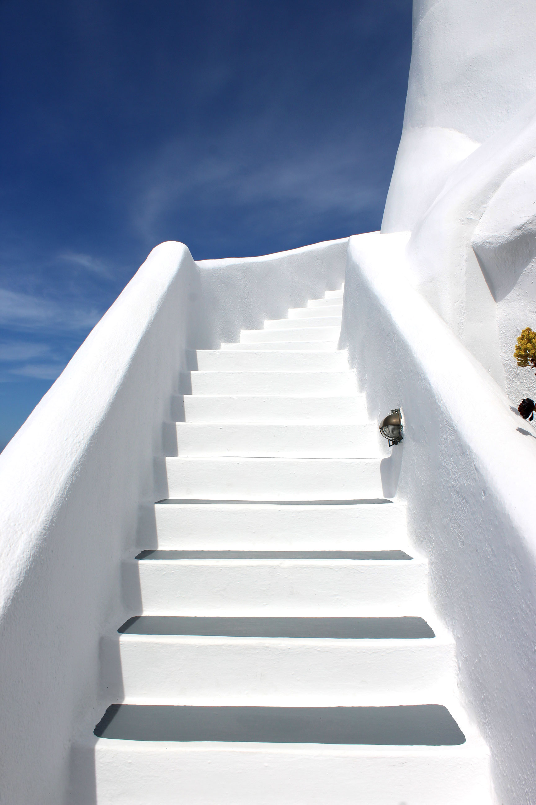 Blue skies and white walls at Ikies Hotel in Santorini.