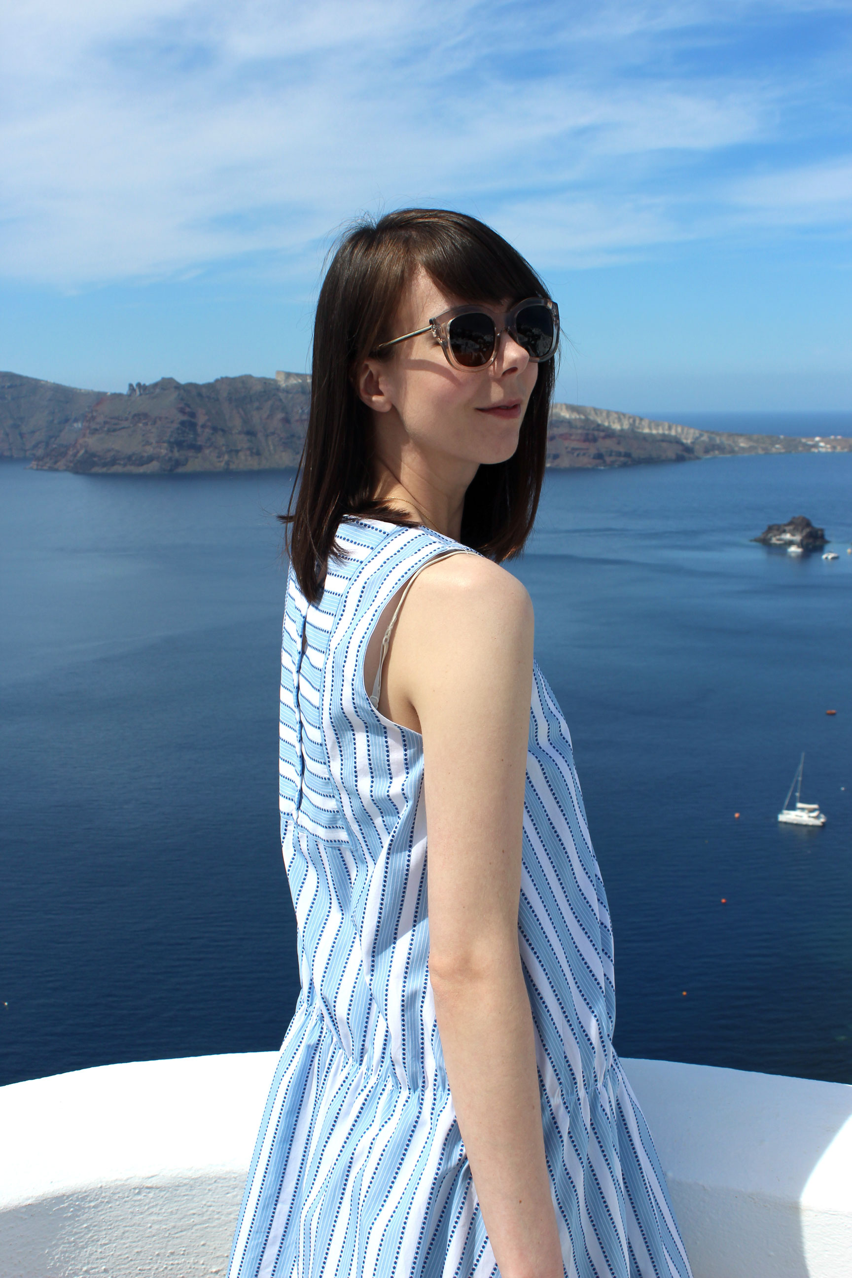 Wearing a Zara dress to match the blue skies and waters of Santorini.