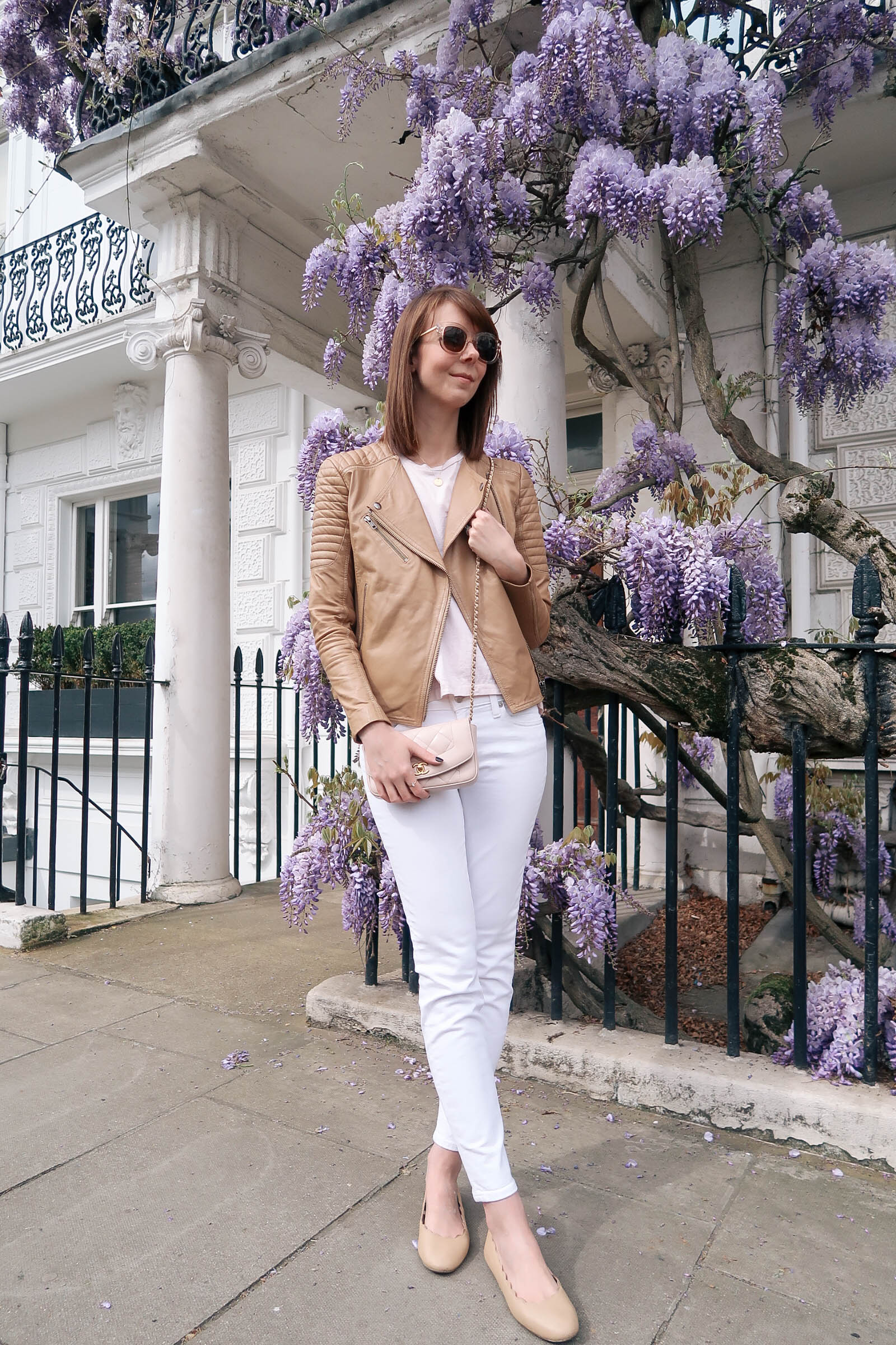 Purple wisteria blossoms in Notting Hill, London wearing J.Crew jeans and a Chanel quilted bag | Pink, Purple and Petals | Sundays and Somedays