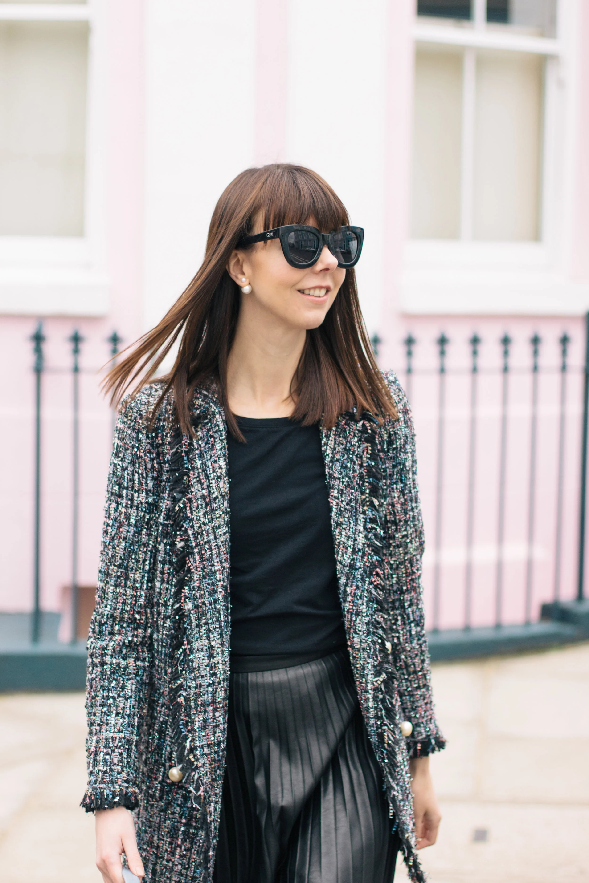 Wandering the colorful streets of Notting Hill wearing a Chanel lookalike jacket, a Cambridge Satchel Company bag, Sam Edelman booties and J.Crew pleated skirt | Pink House, Blue Bag | Sundays and Somedays