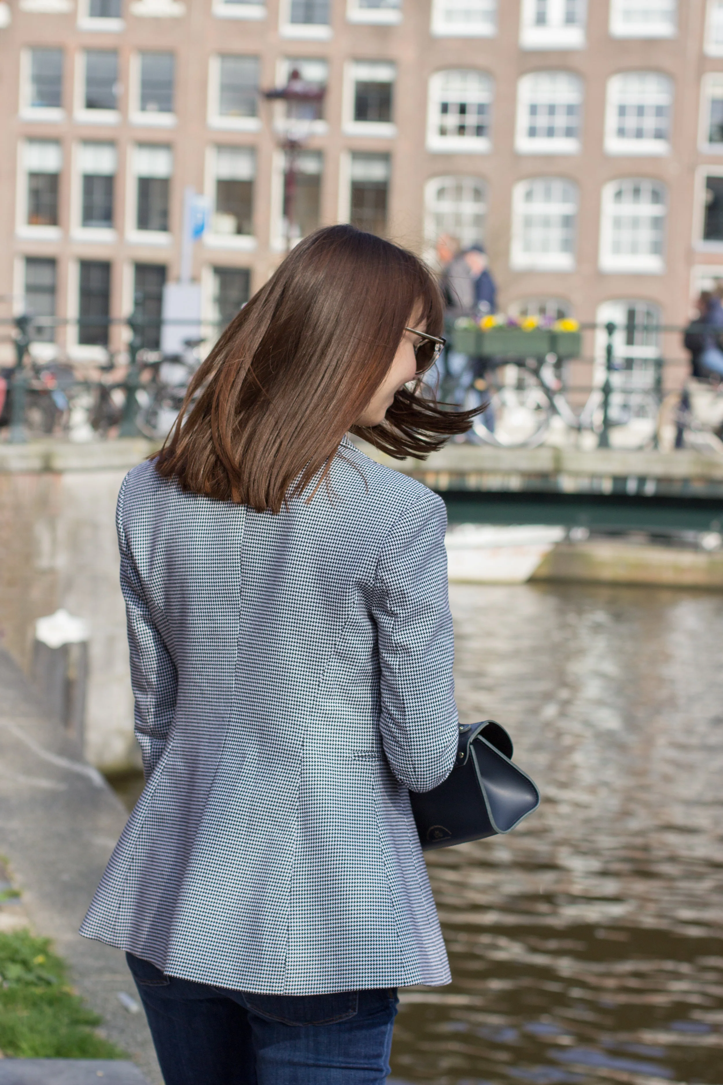 Wearing the checked blue and white blazer for spring over a lace top, delicate accessories and a Cambridge Satchel Company Daisy bag for spring in Amsterdam.
