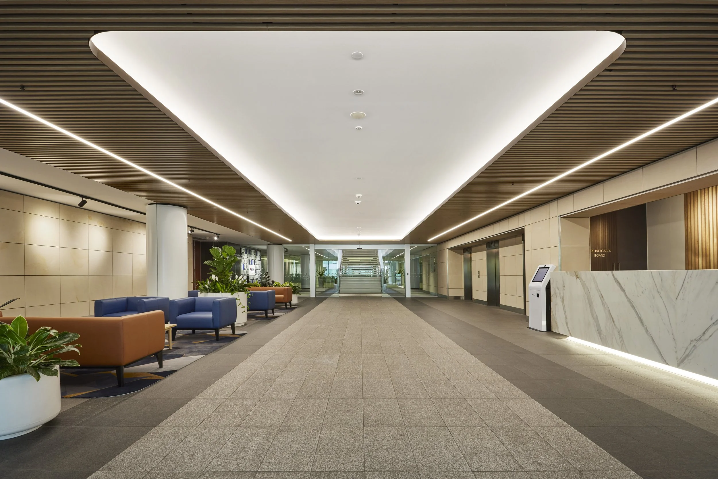Modern hotel lobby with seating area and elevator access