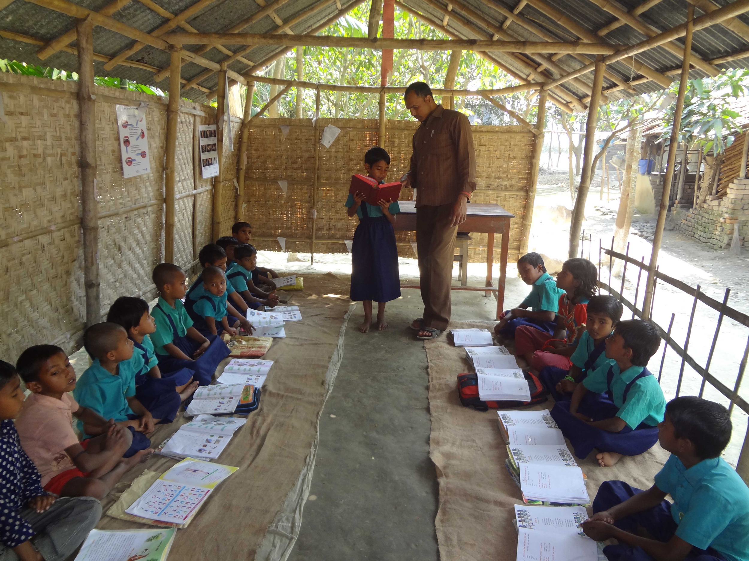 A child reads the Bible in the Jamalnagor CDC.JPG