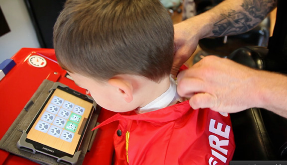 Apply the neck strip and close the collar of the jacket to keep hair off of the child. Wash the cape regularly, HANG DRY ONLY.
