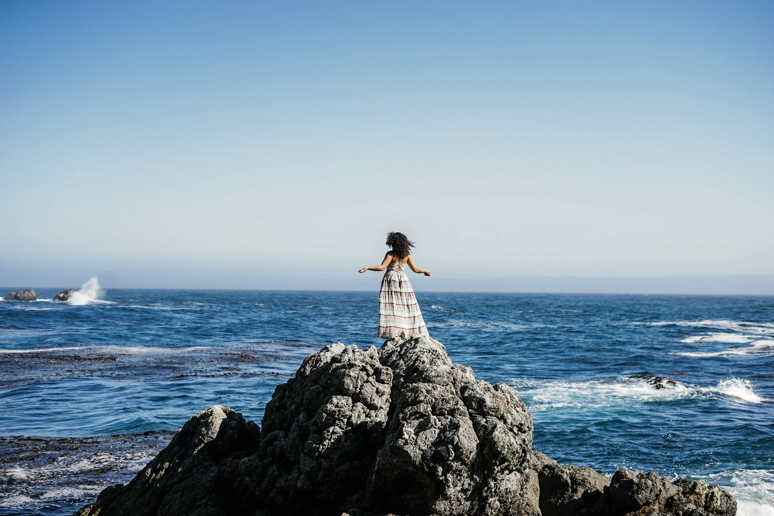 Environmental portrait of Sydney of rocks and ocean in Big Sur California