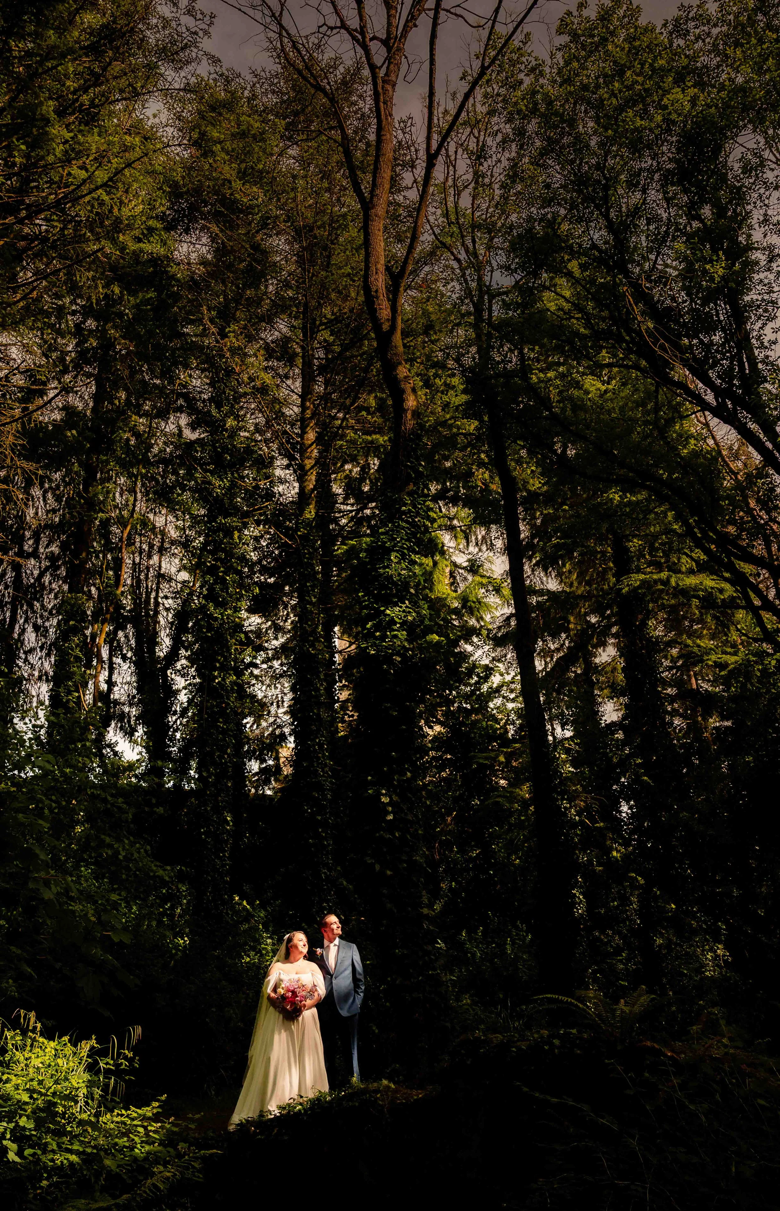couple in a spotlight in the forest next to wilton Castle