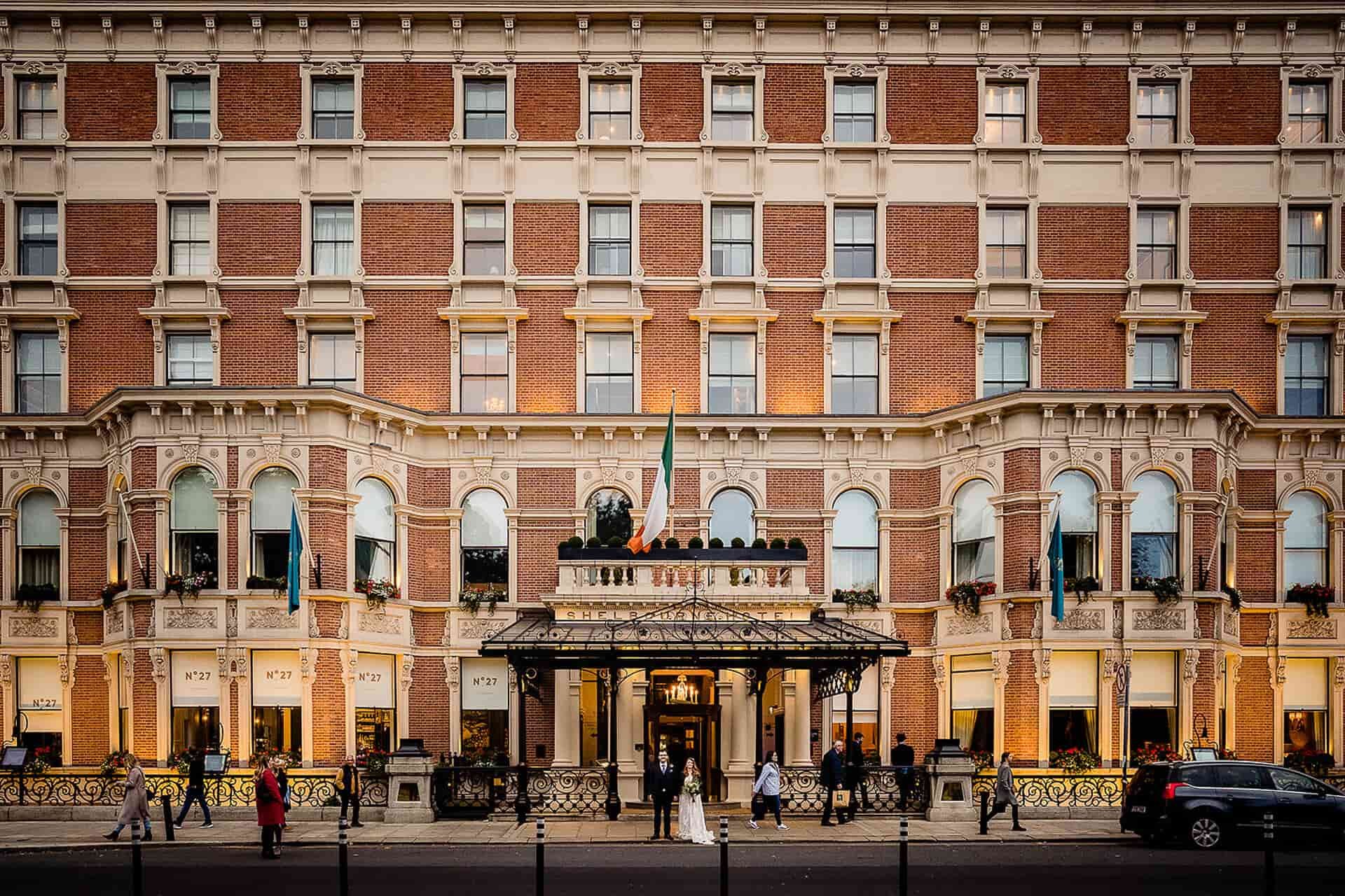 Wide view of The Shelbourne Hotel facade at dusk on a Dublin wedding day