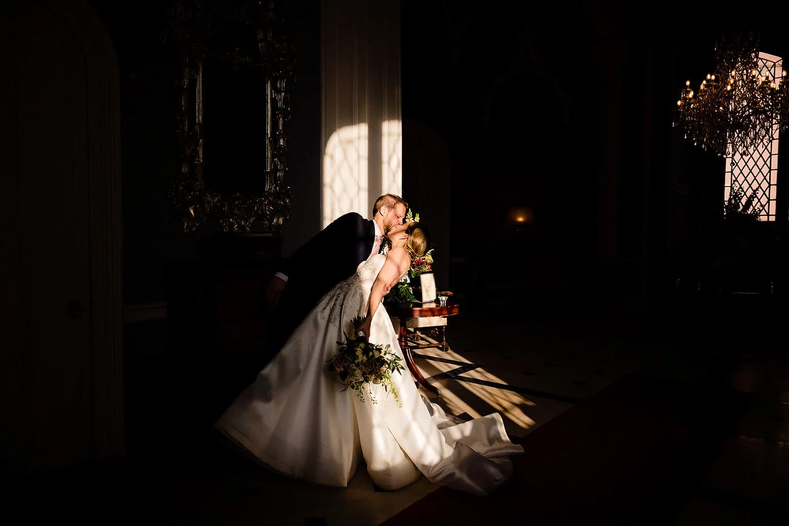 married couple doing a dip in high contrast light in luttresltown castle photographed by award winning photographer kevin kheffache