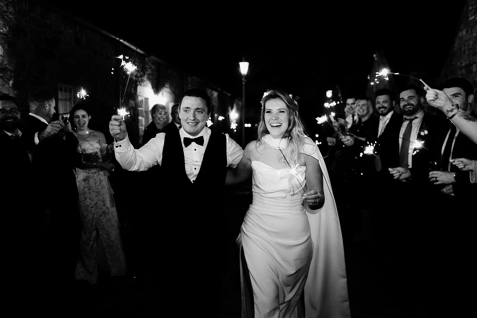 Wedding photograph of a married couple doing a sparkler run in carton house