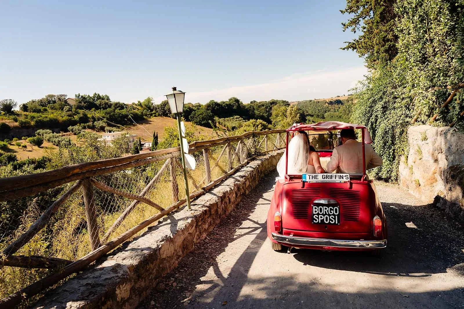 10. Niamh and Dave in the red Fiat with The Gloves brass band behind them at Borgo di Tragliata-2.jpg