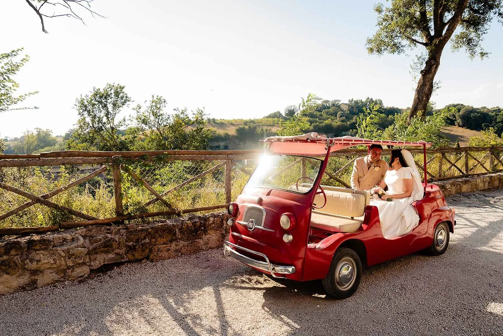 10. Niamh and Dave in the red Fiat with The Gloves brass band behind them at Borgo di Tragliata-9.jpg