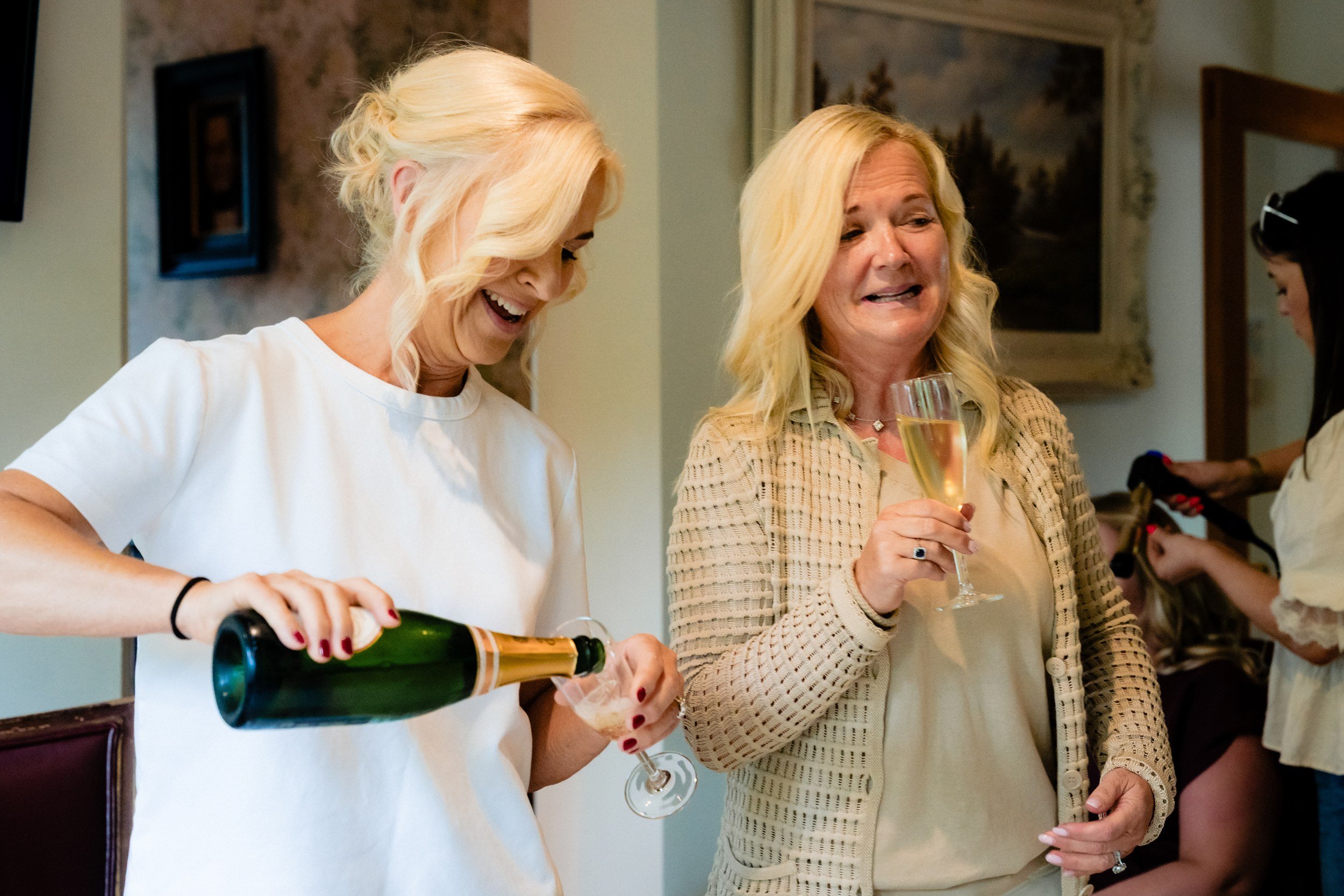 galgorm-wedding-photographer-holly-matt-04-mum-pouring-champagne.jpg