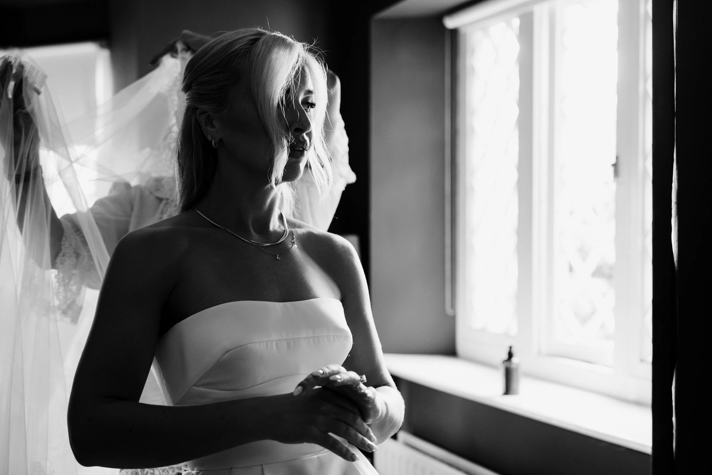 galgorm-wedding-photographer-holly-matt-10-holly-at-the-window.jpg