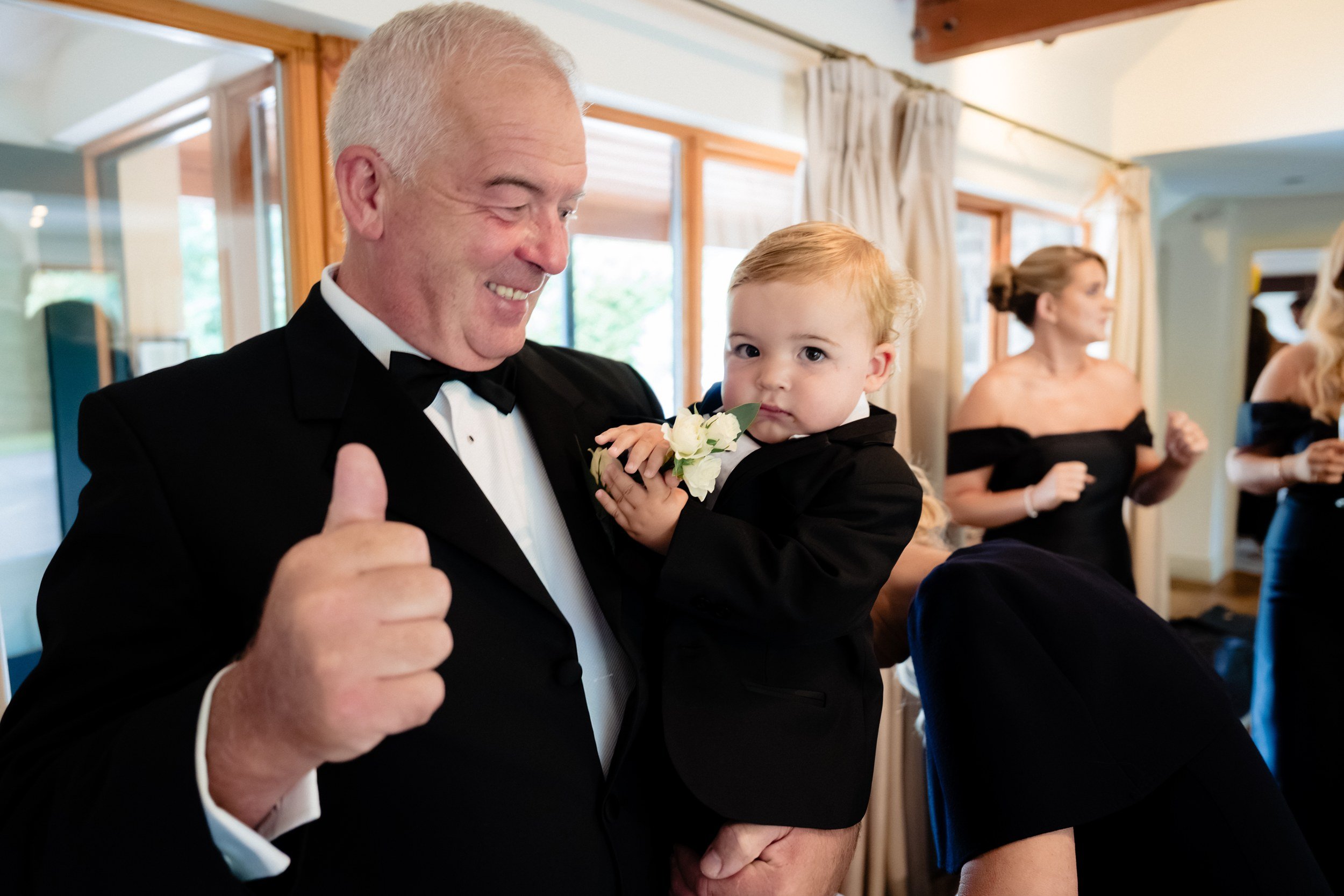 galgorm-wedding-photographer-holly-matt-21-dad-thumbs-up-with-baby.jpg