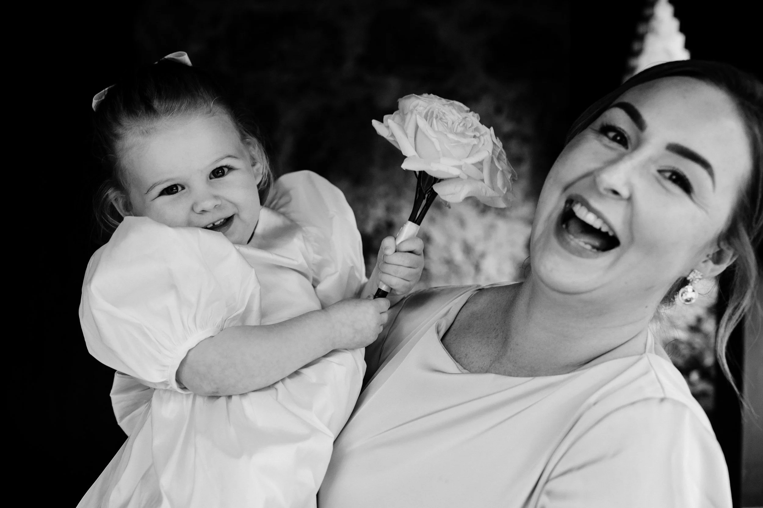 galgorm-wedding-photographer-holly-matt-29-flower-girl-laughing.jpg