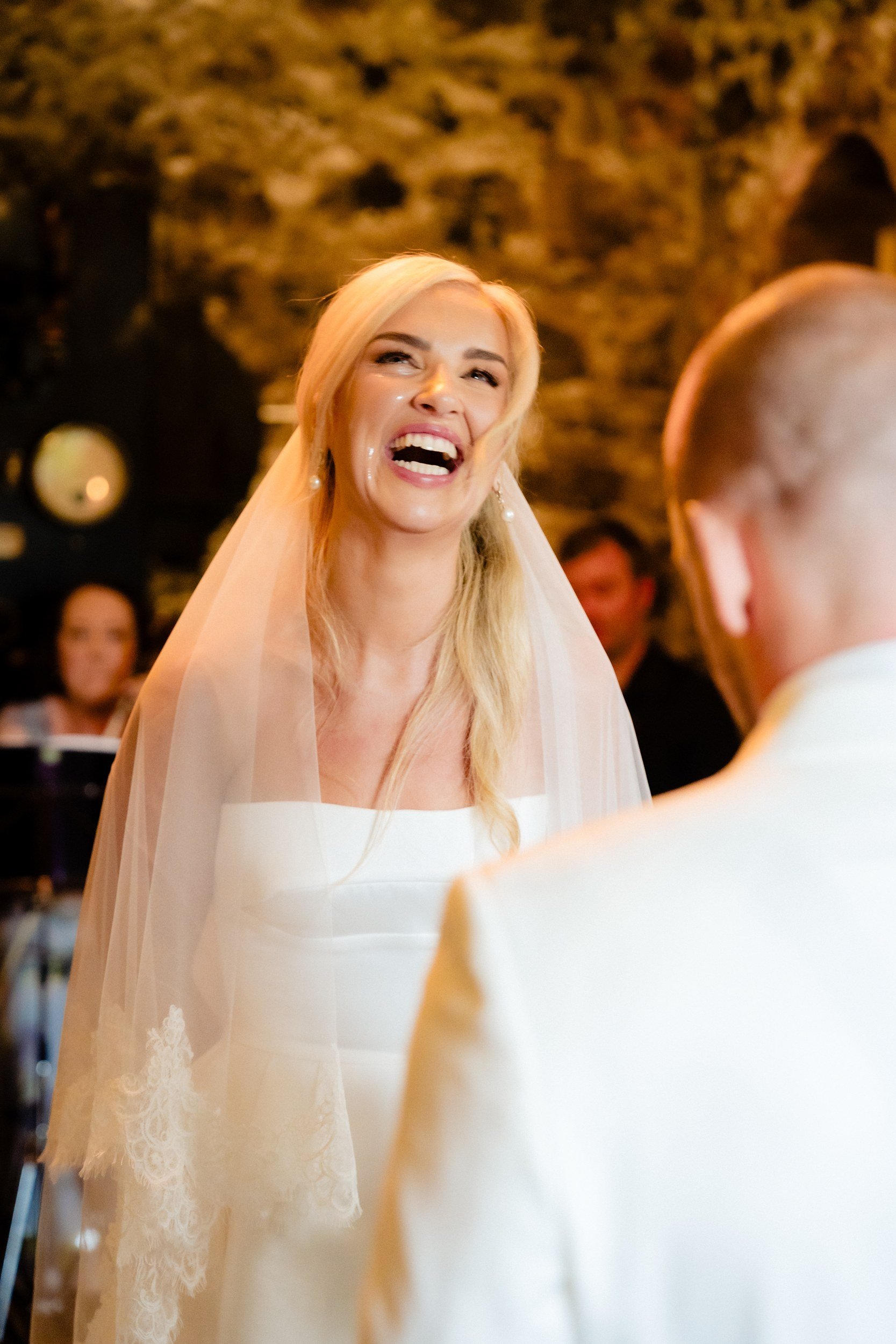 galgorm-wedding-photographer-holly-matt-38-holly-laughing-during-vows.jpg