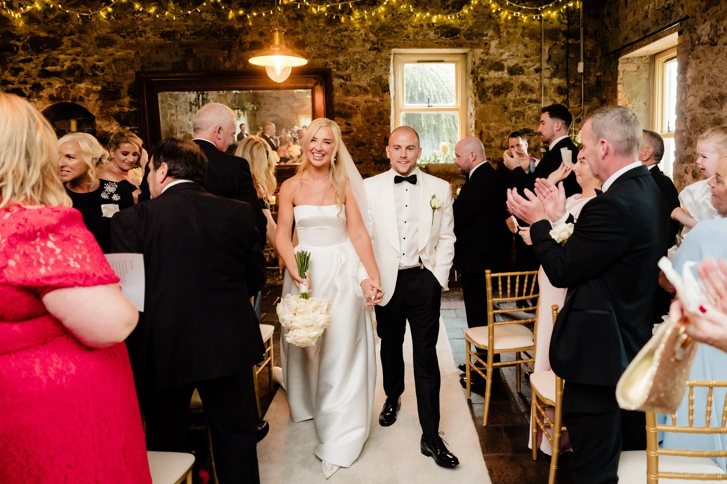galgorm-wedding-photographer-holly-matt-42-walking-back-down-the-aisle.jpg