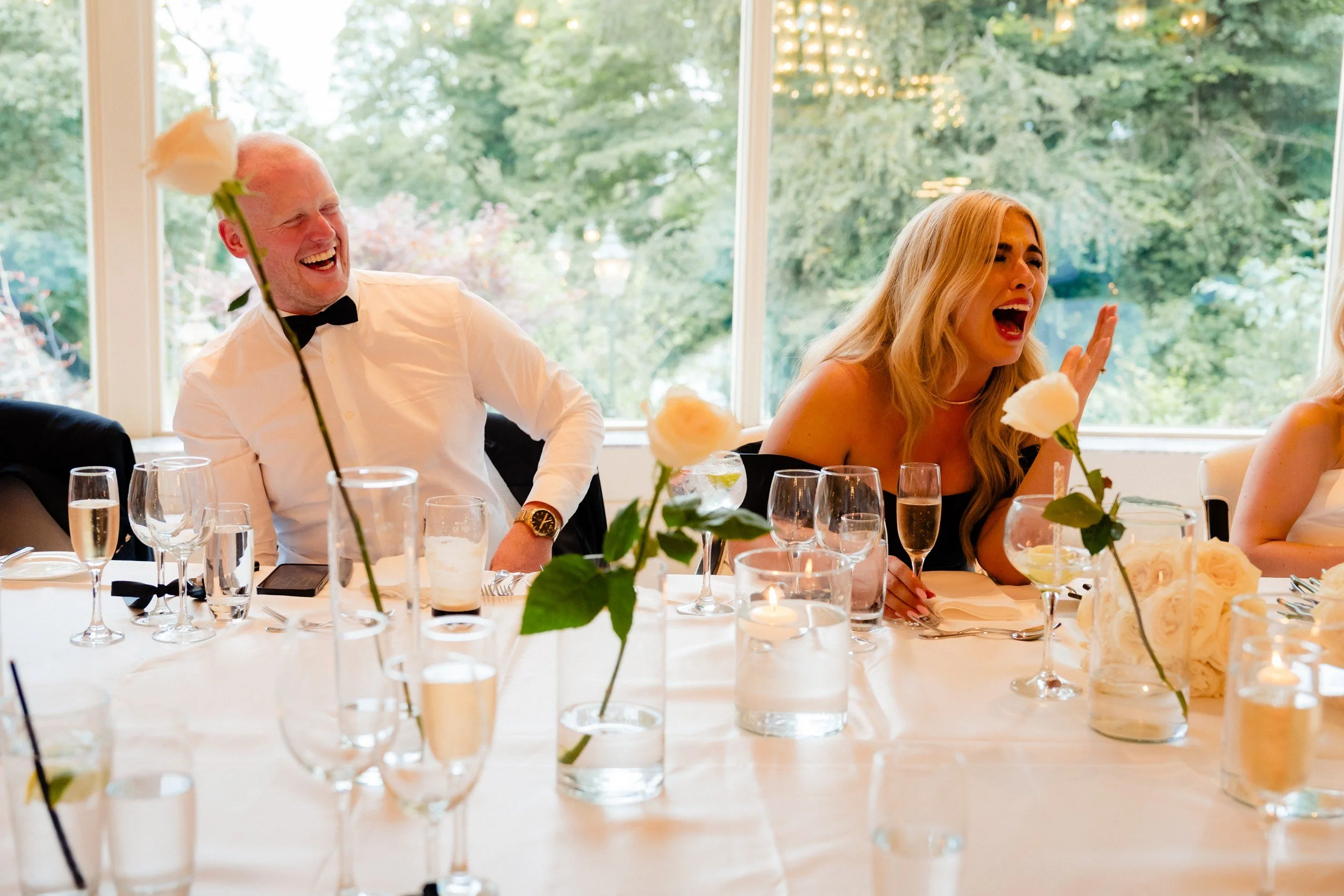 galgorm-wedding-photographer-holly-matt-57-holly-and-matt-laughing-during-speeches.jpg