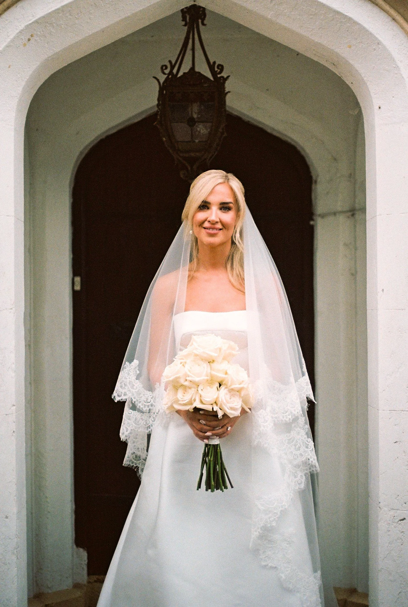 galgorm-wedding-photographer-holly-matt-72-film-holly-in-the-doorway.jpg