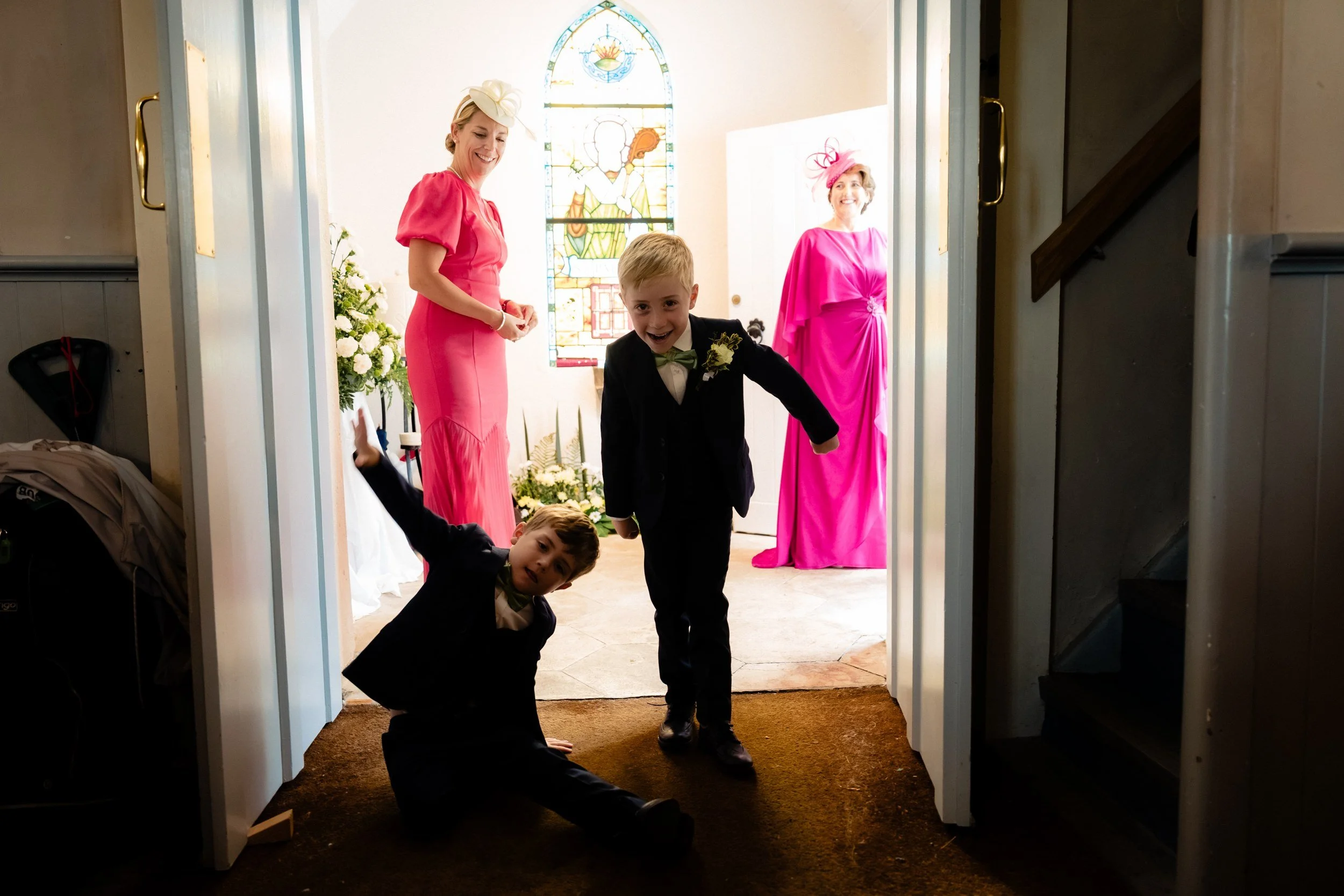 tinakilly-wedding-photographer-laura-james-16-page-boys-running-into-the-church.jpg