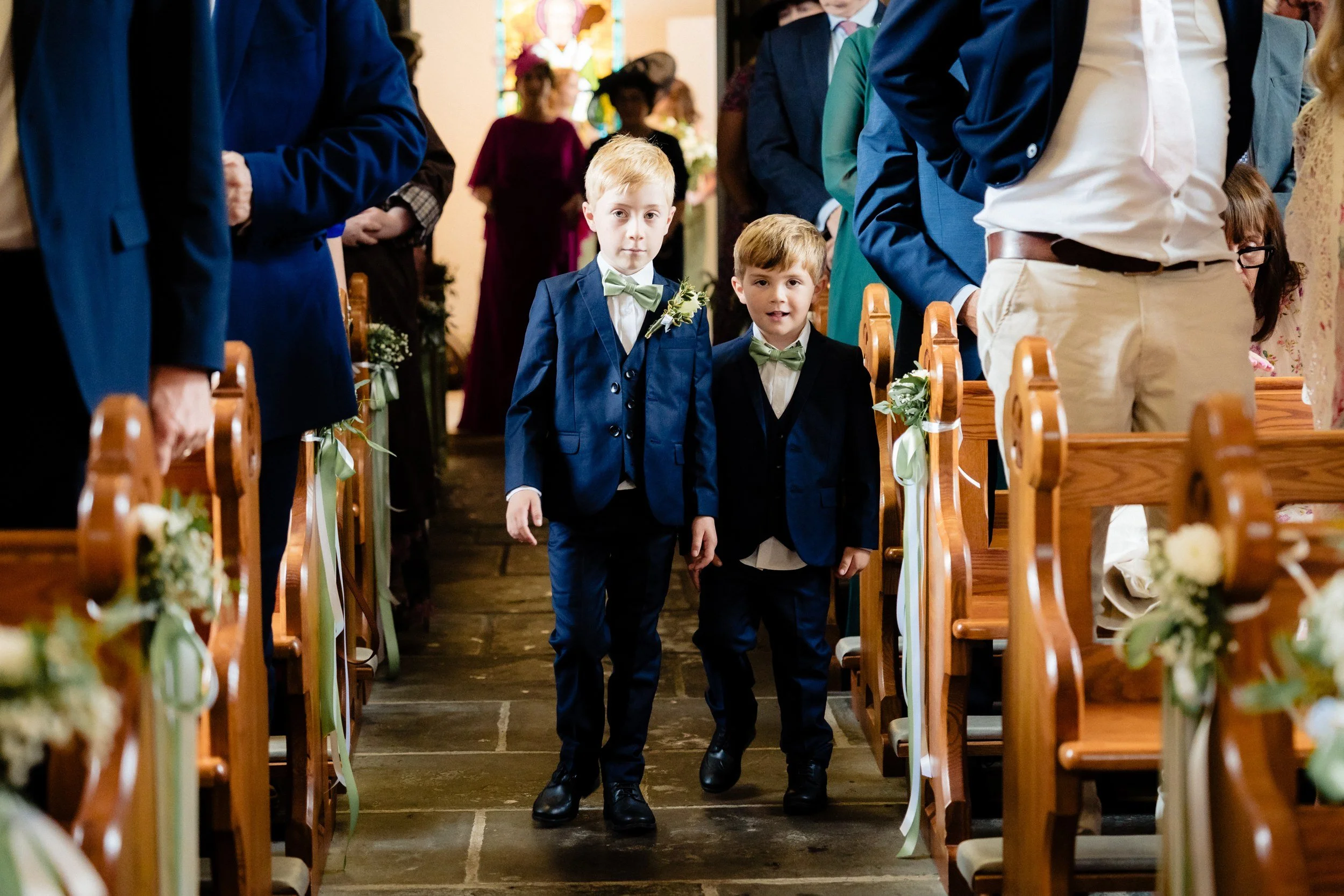 tinakilly-wedding-photographer-laura-james-22-page-boys-walking-the-aisle.jpg