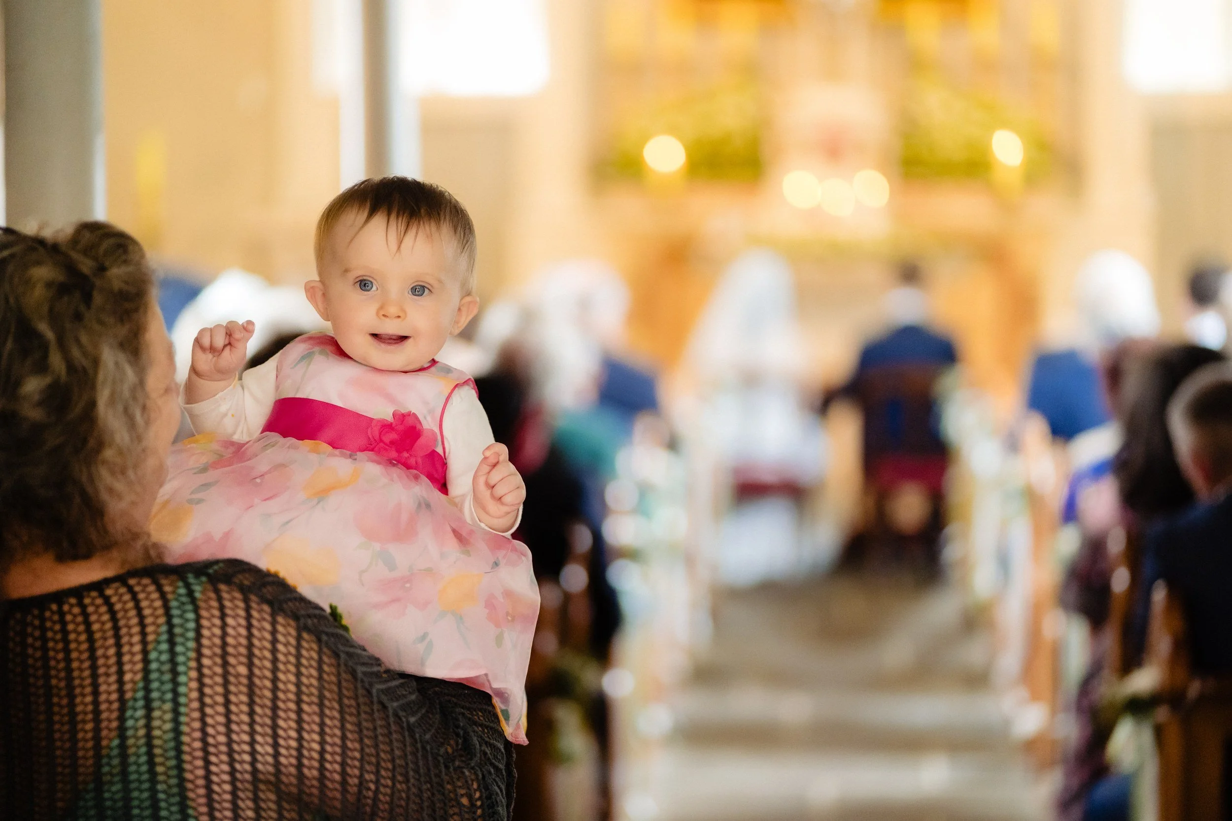tinakilly-wedding-photographer-laura-james-31-baby-waving-in-the-pews.jpg