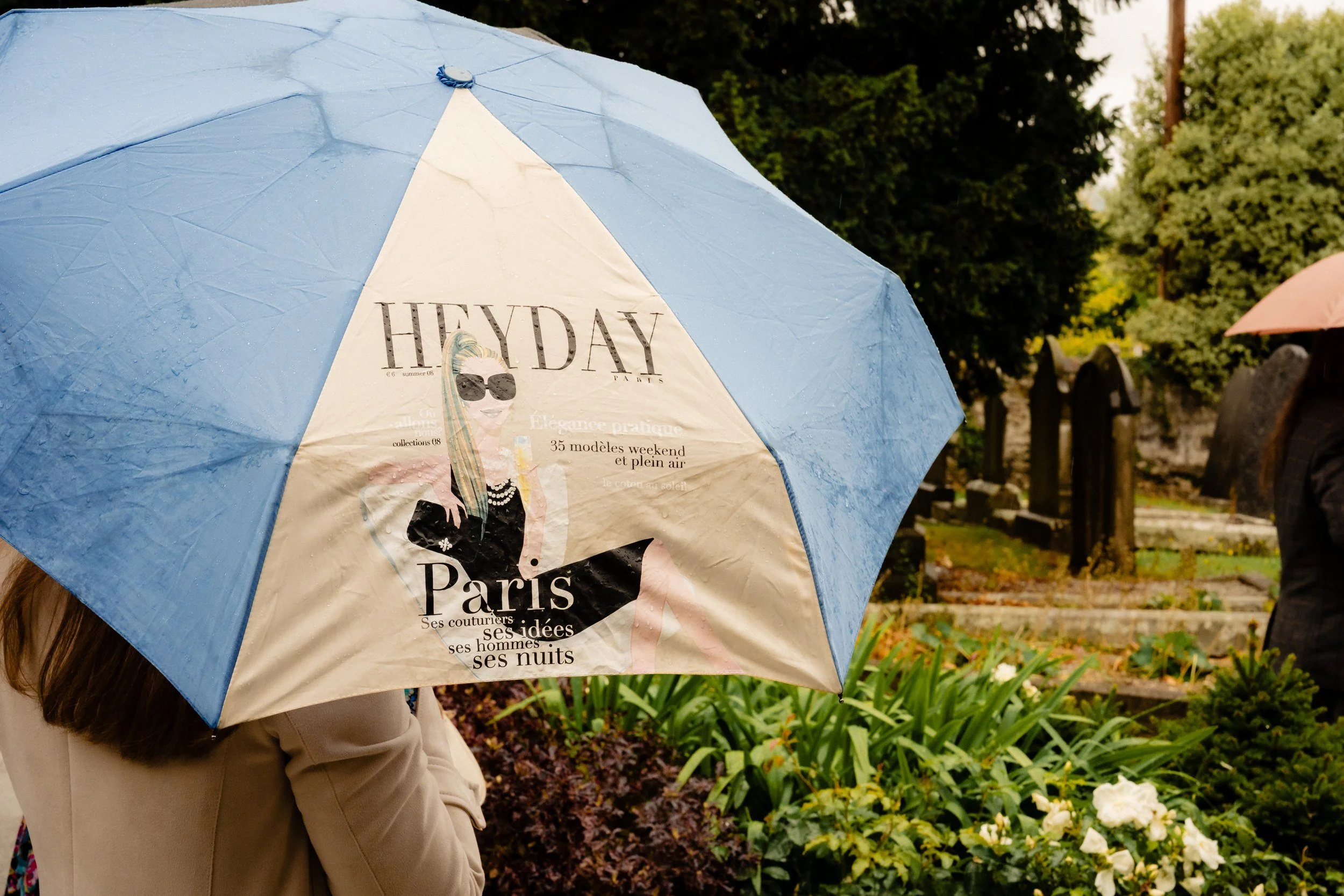 tinakilly-wedding-photographer-laura-james-35-heyday-umbrella-in-the-churchyard.jpg