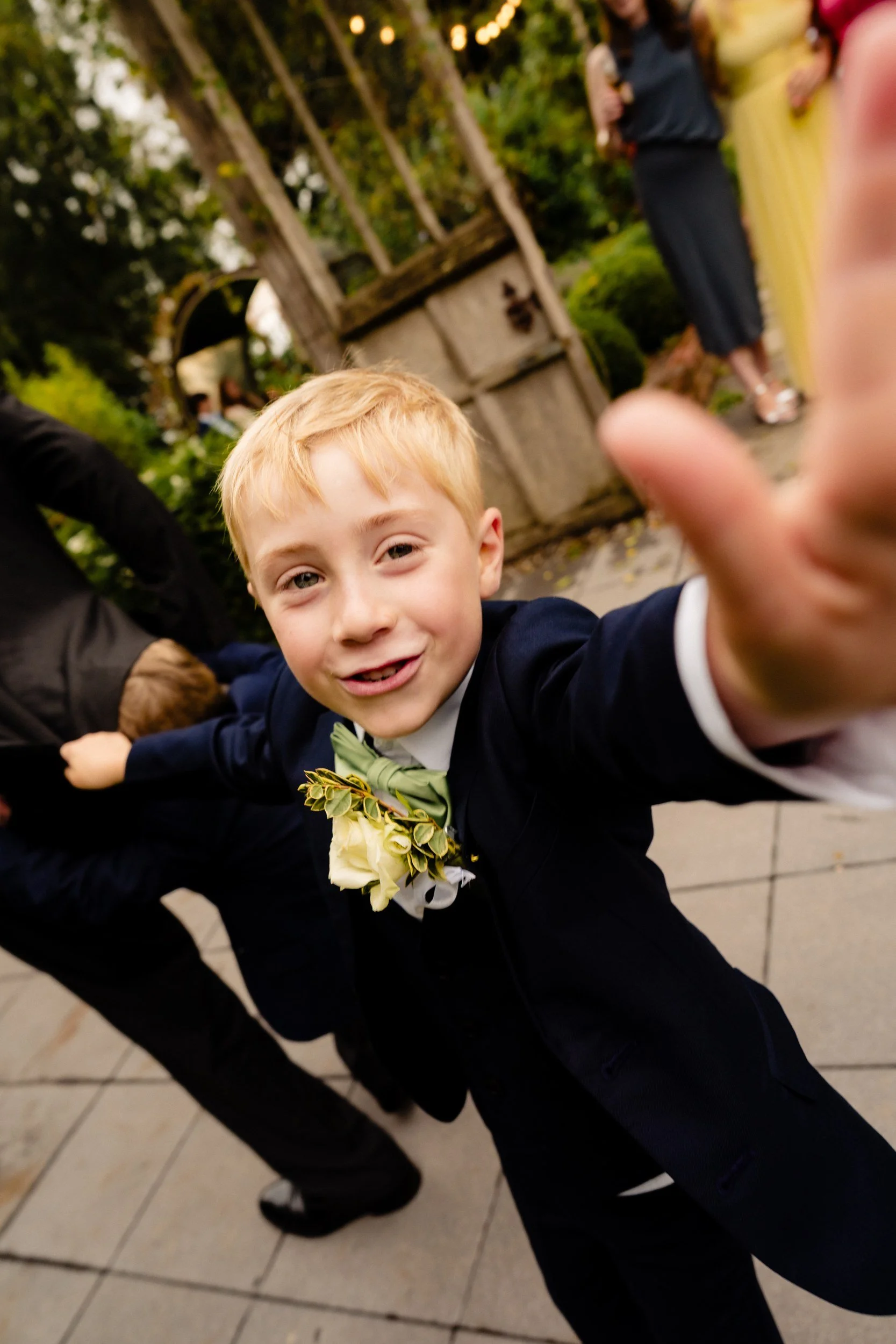 tinakilly-wedding-photographer-laura-james-44-page-boy-jumping-at-the-camera.jpg