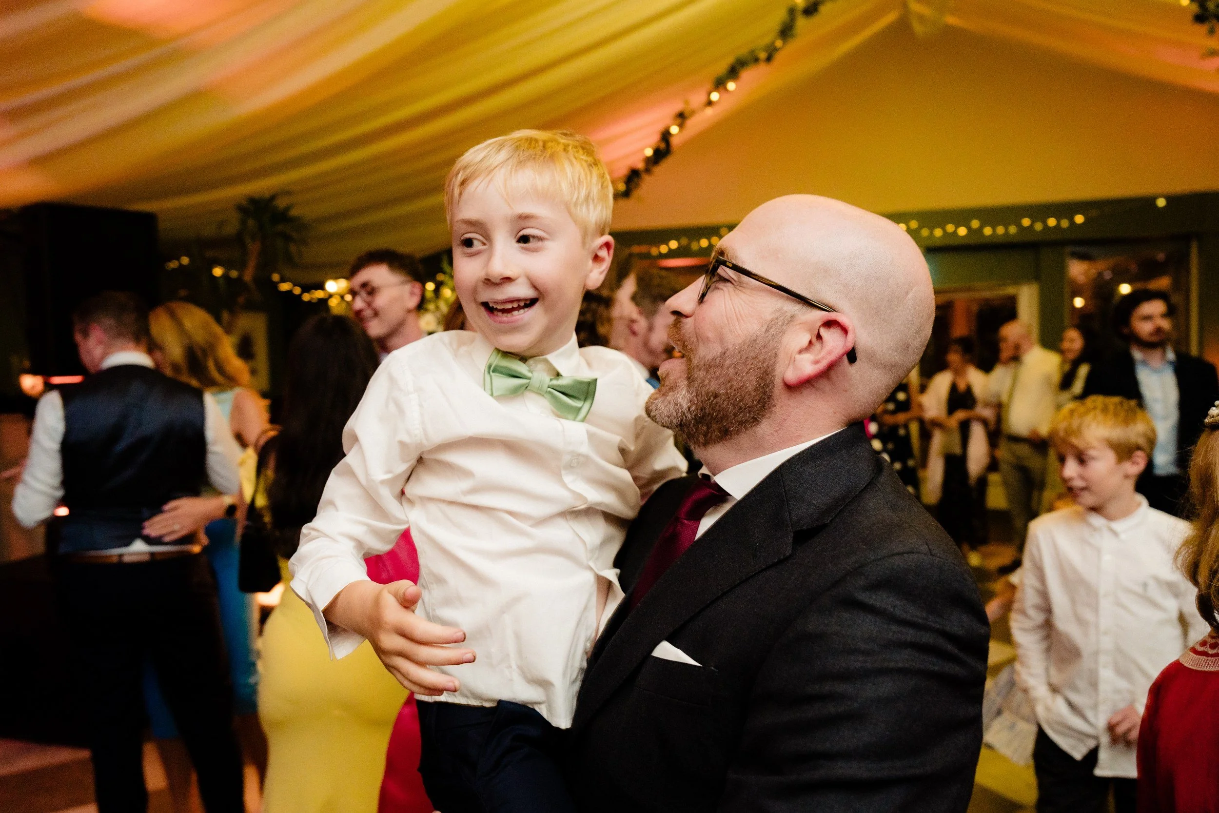 tinakilly-wedding-photographer-laura-james-72-page-boy-lifted-on-the-dance-floor.jpg