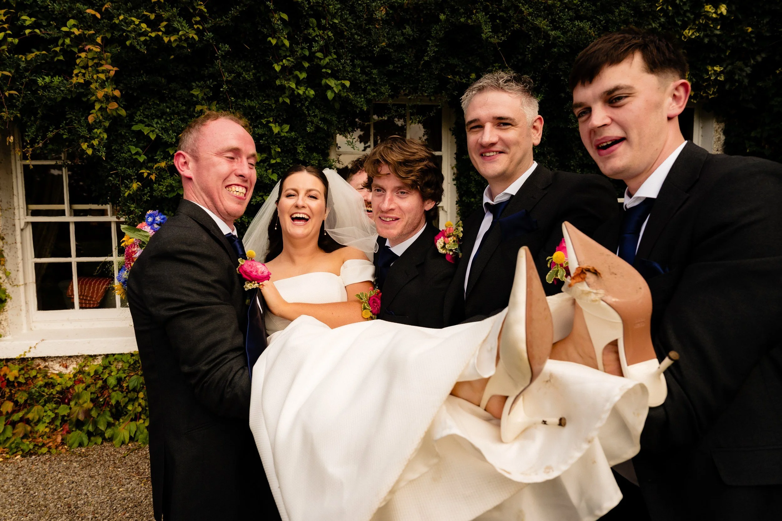 rathsallagh-wedding-photographer-niamh-john-63-groomsmen-lift-bride.jpg