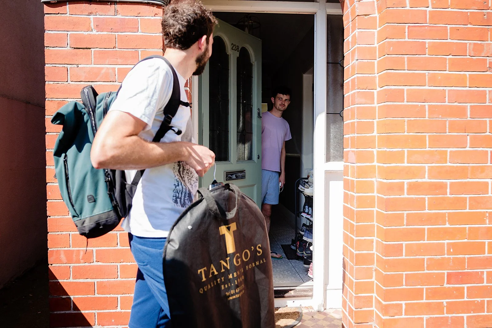 marco-pierre-white-wedding-photographer-elle-iain-01-groomsman-arriving-with-suit-at-sundrive-road.jpg