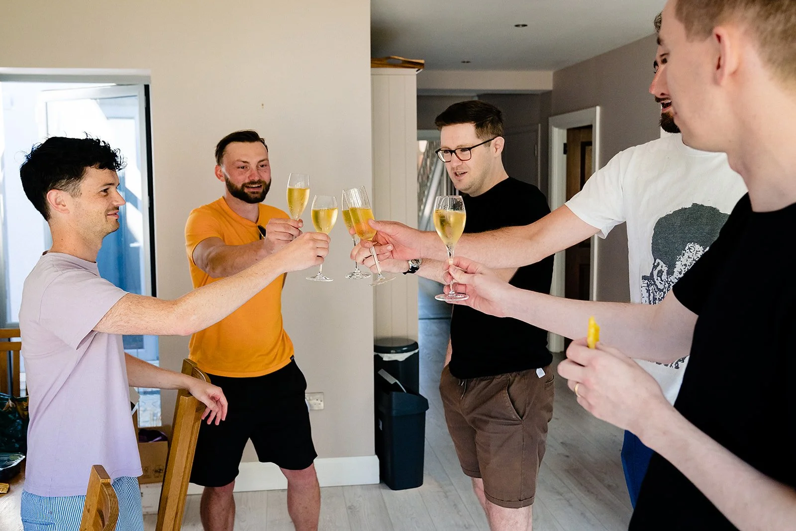 marco-pierre-white-wedding-photographer-elle-iain-04-groomsmen-toasting-in-the-kitchen.jpg