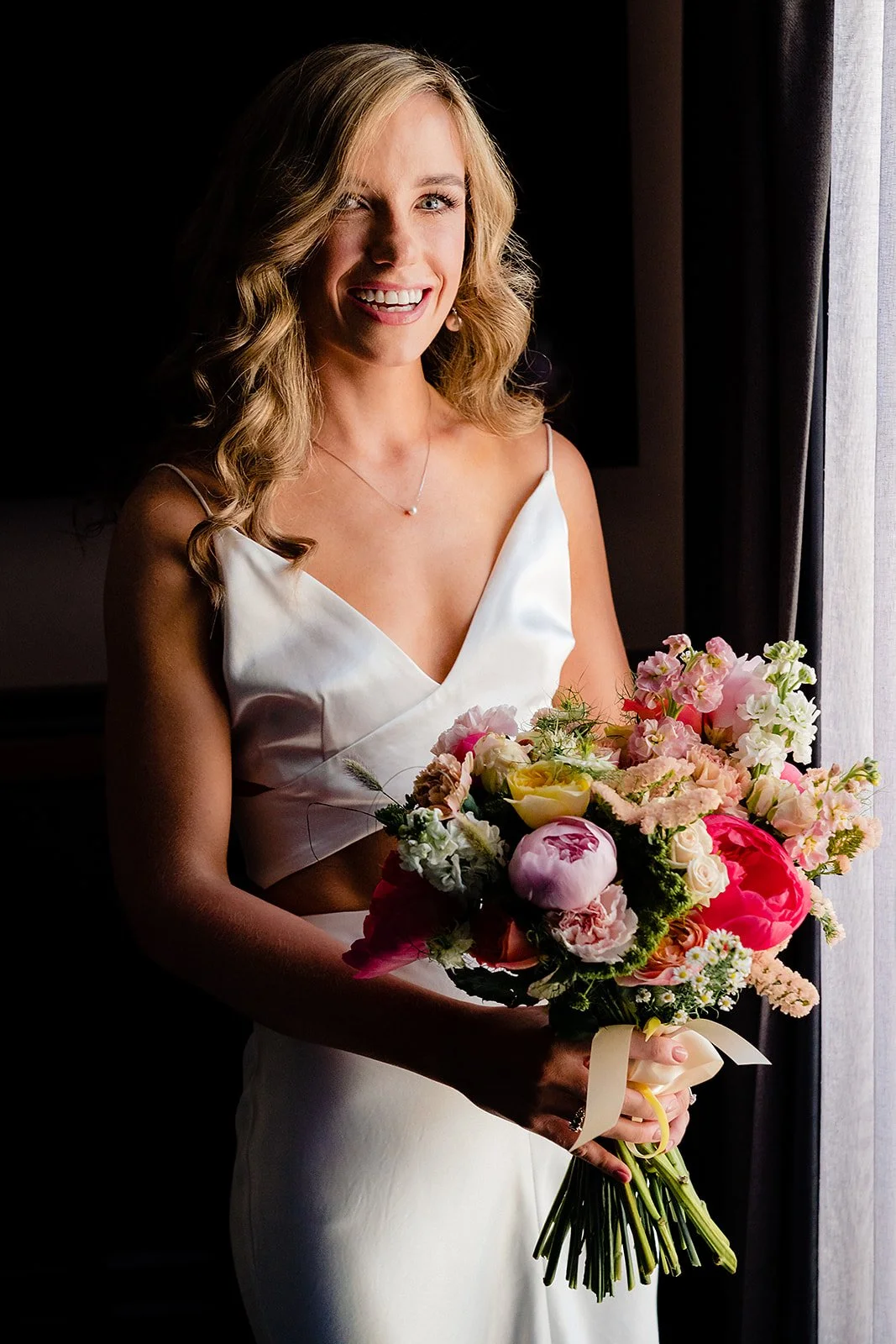 marco-pierre-white-wedding-photographer-elle-iain-20-elle-with-her-bouquet-by-the-window.jpg