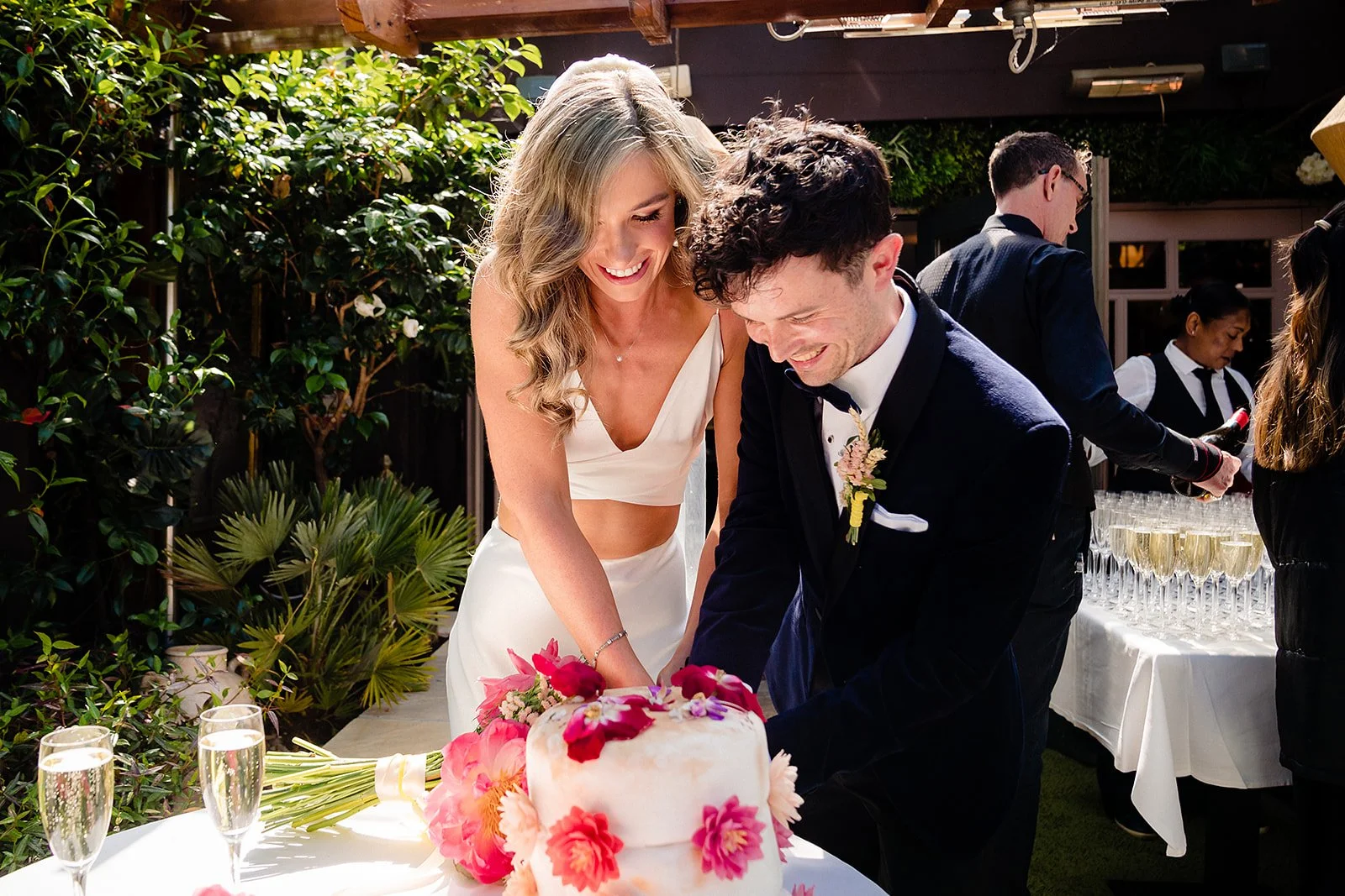 marco-pierre-white-wedding-photographer-elle-iain-43-cutting-the-cake-in-the-courtyard.jpg