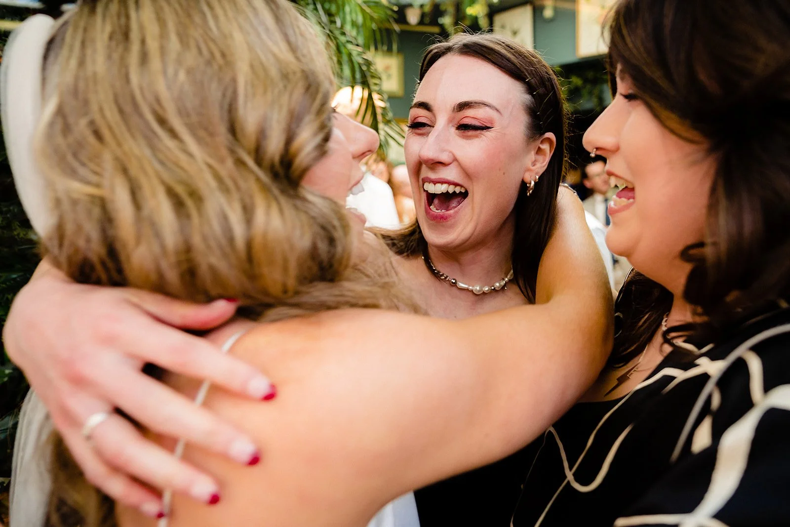 marco-pierre-white-wedding-photographer-elle-iain-47-elle-hugging-a-friend-in-the-courtyard.jpg