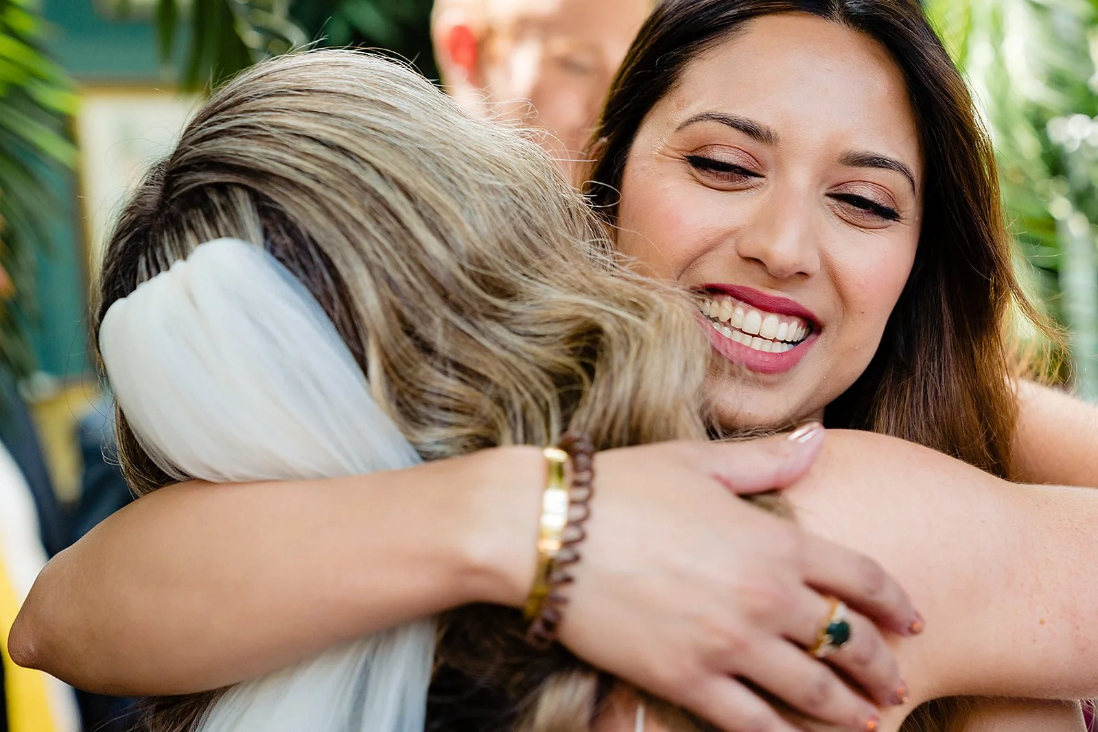 marco-pierre-white-wedding-photographer-elle-iain-48-elle-hugging-a-guest-in-the-sun.jpg