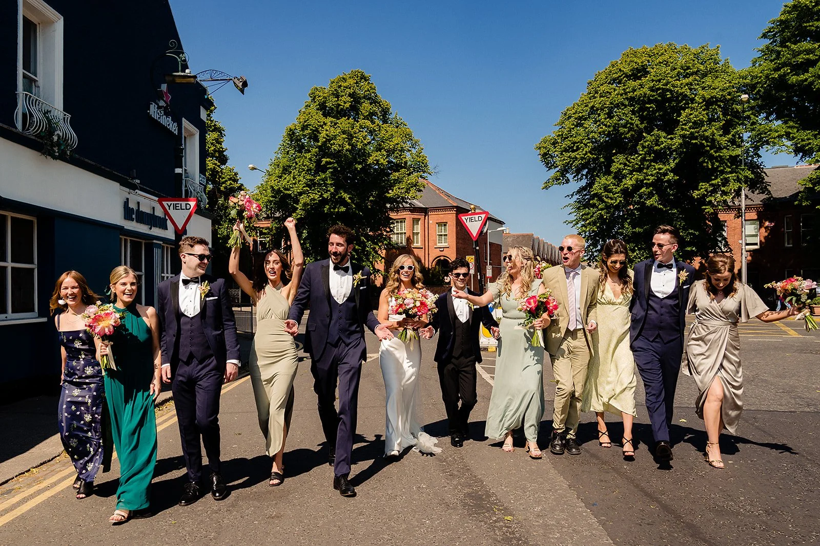marco-pierre-white-wedding-photographer-elle-iain-54-bridal-party-walking-down-the-street.jpg