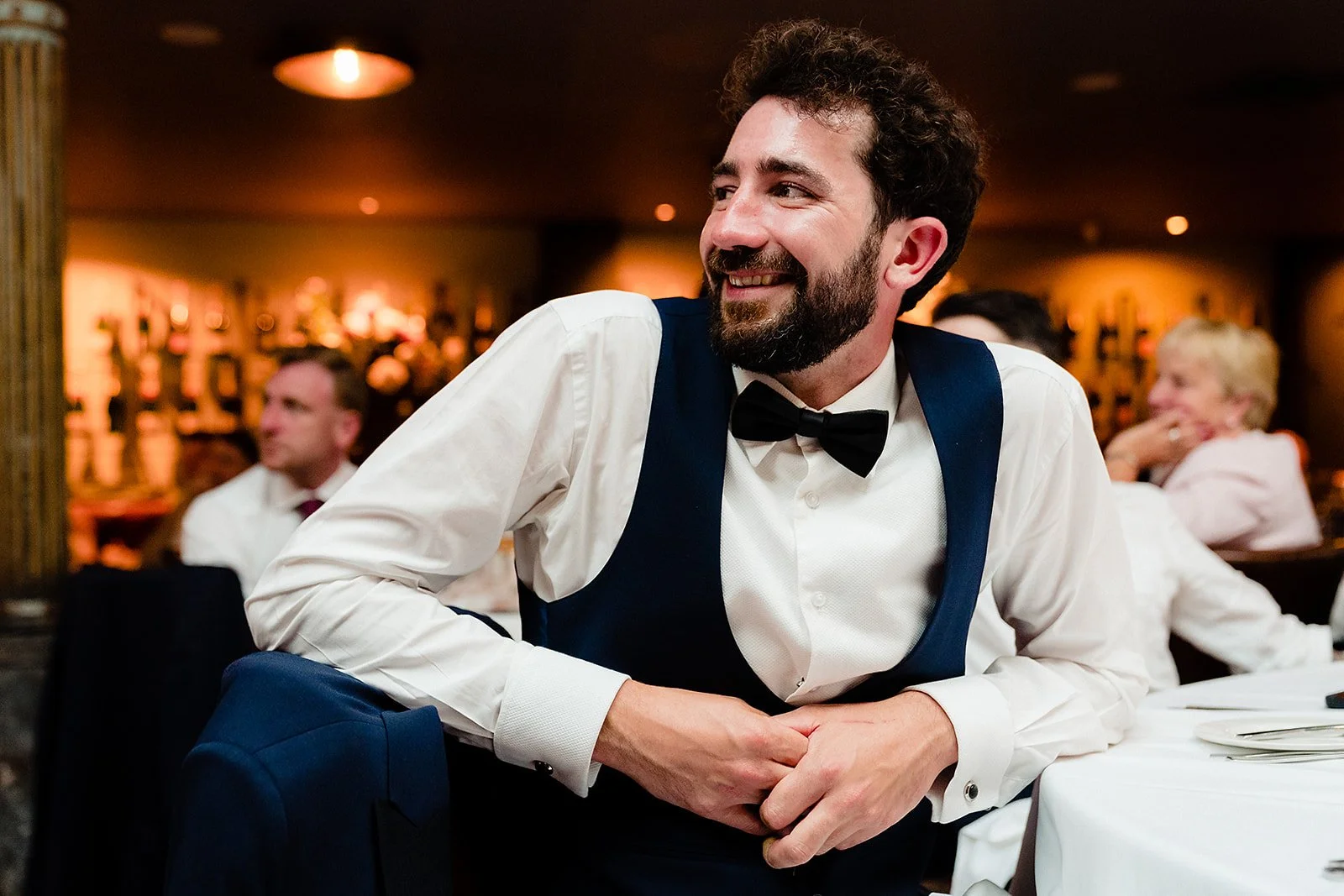 marco-pierre-white-wedding-photographer-elle-iain-68-guest-grinning-at-the-speeches.jpg