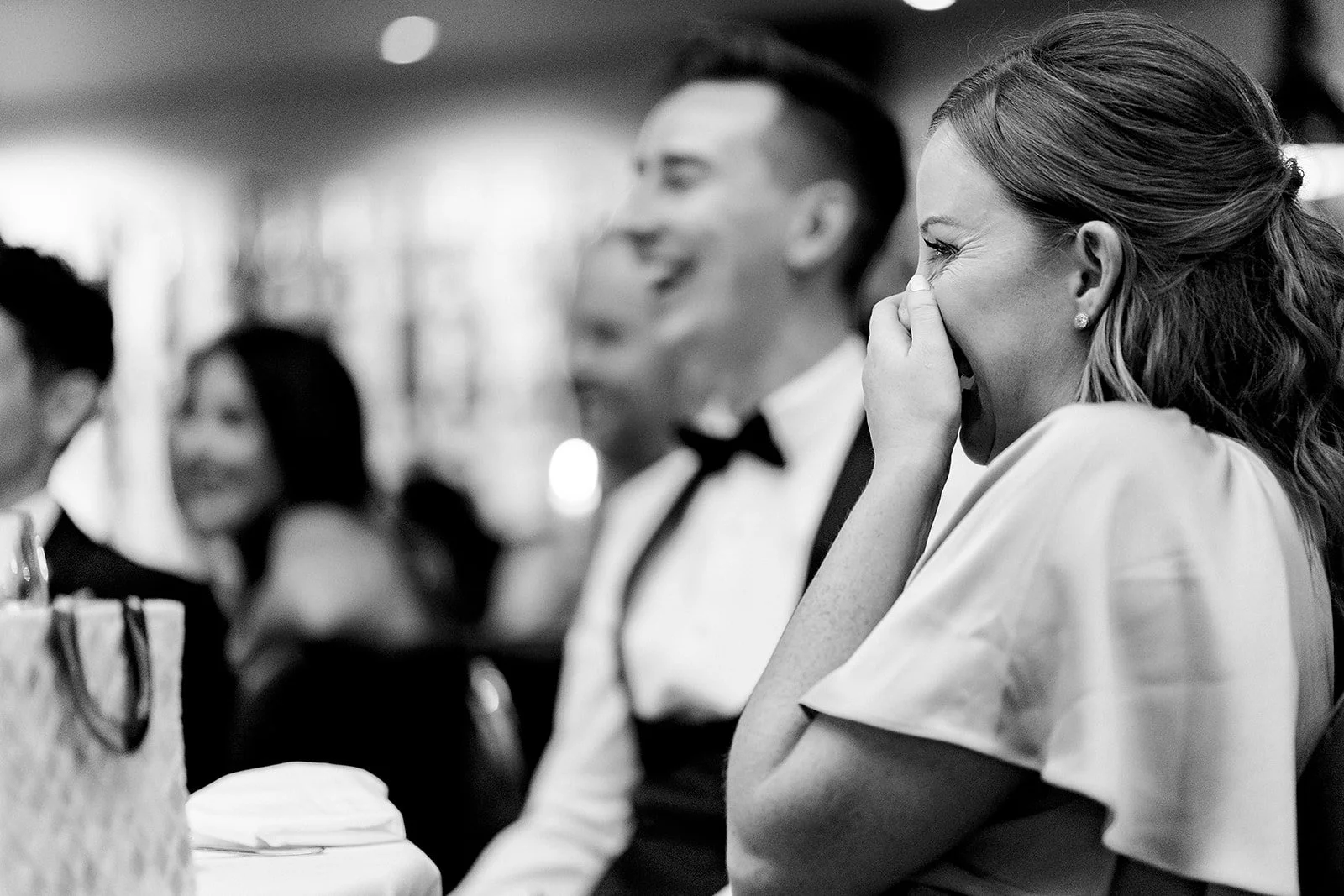marco-pierre-white-wedding-photographer-elle-iain-71-guests-laughing-in-black-and-white.jpg