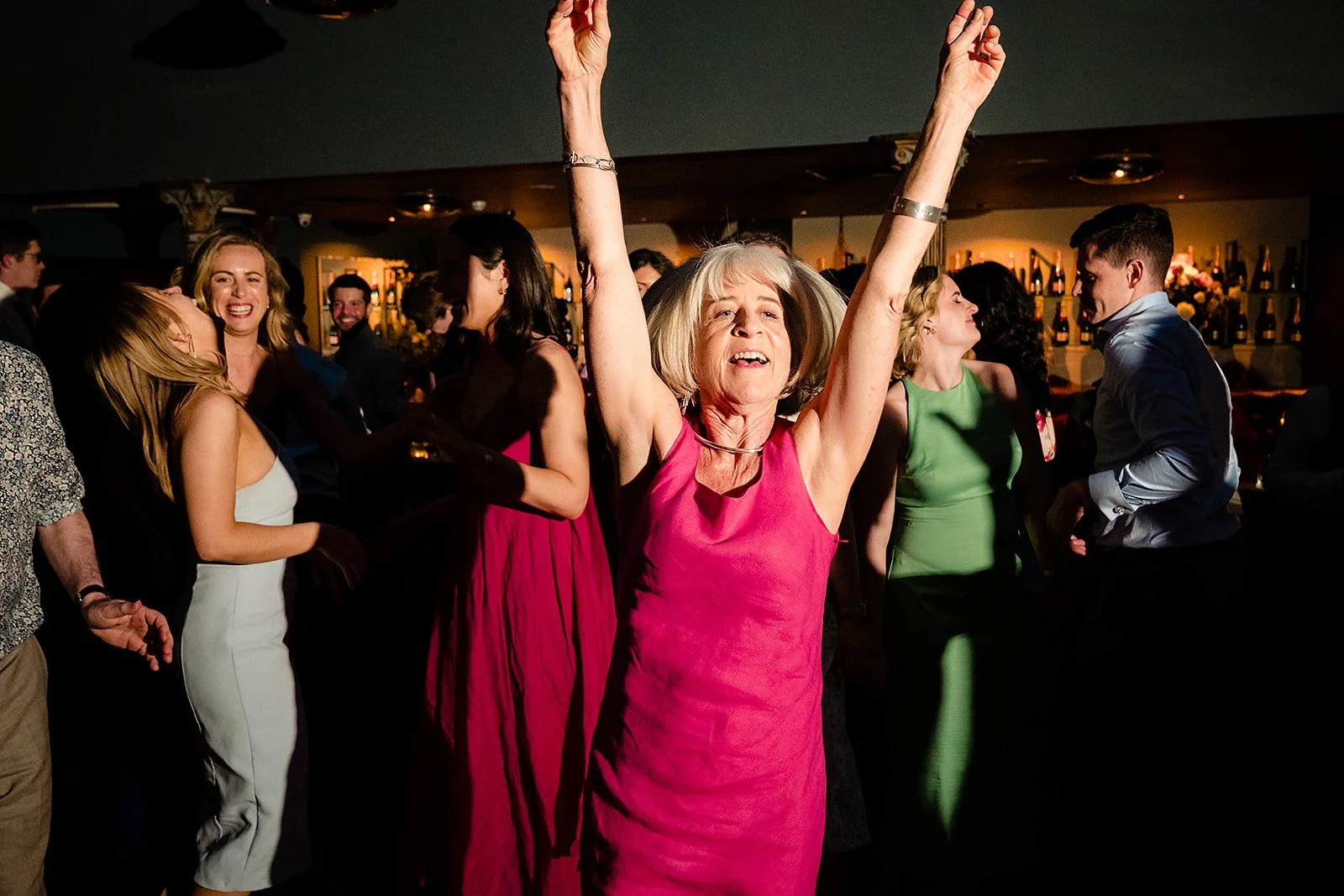 marco-pierre-white-wedding-photographer-elle-iain-76-guest-with-arms-in-the-air-on-the-dance-floor.jpg
