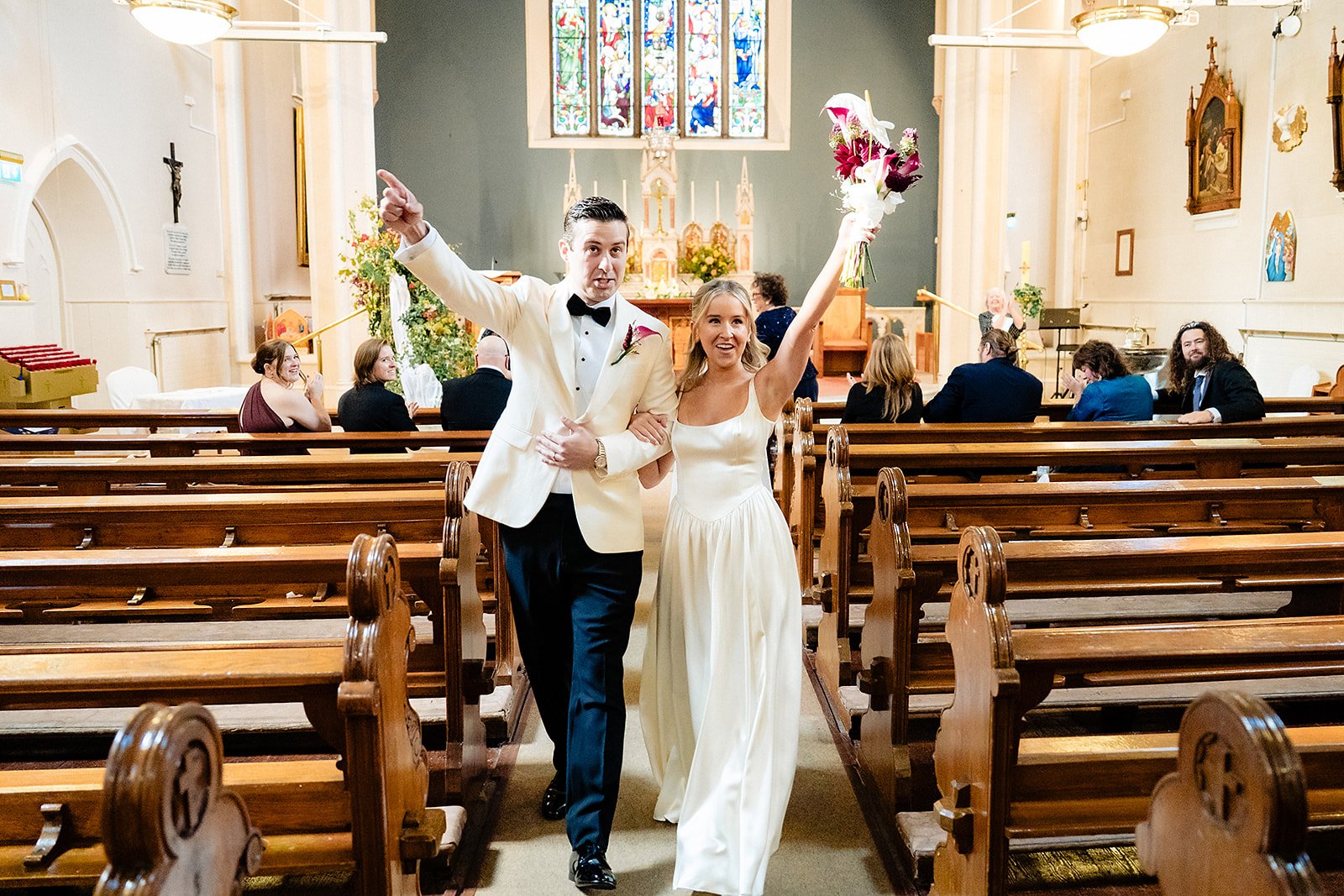 lough-tay-wedding-photographer-casey-dominic-04-recessional-arms-raised-bouquet.jpg