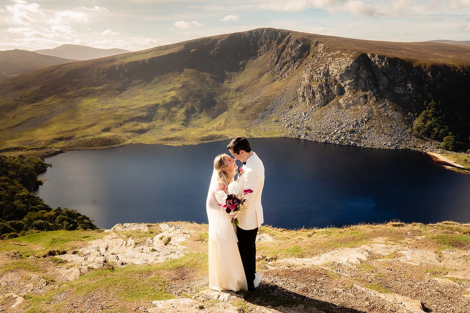 wide landscape photog of casey and dominic at the top o fthe guiness lake in tough tay.